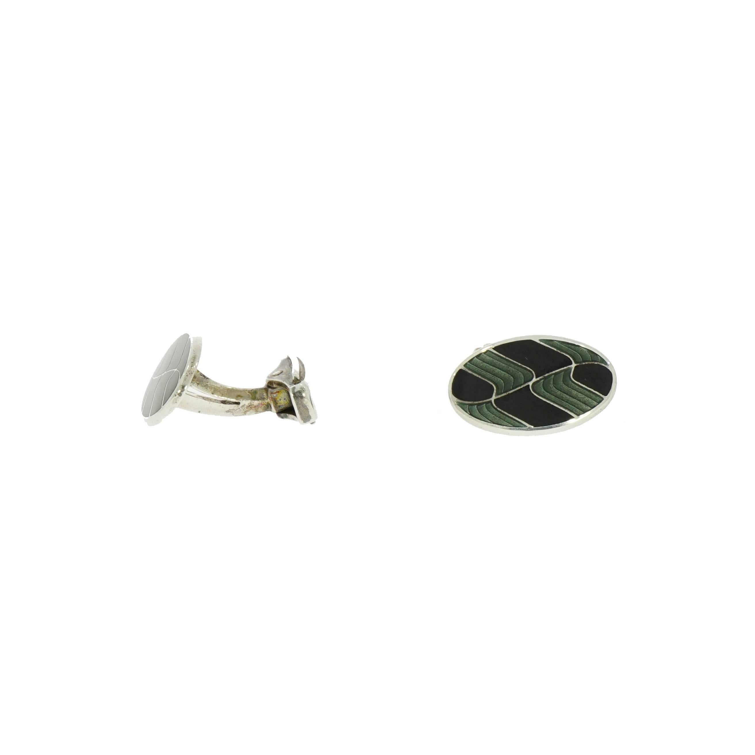 Today's well-dressed man cares about how he looks and enjoys setting himself apart with distinctive accessories like this handsome wavy green/black enameled oval cufflinks designed by Brixton & Gill (England). Handcrafted in sterling silver and