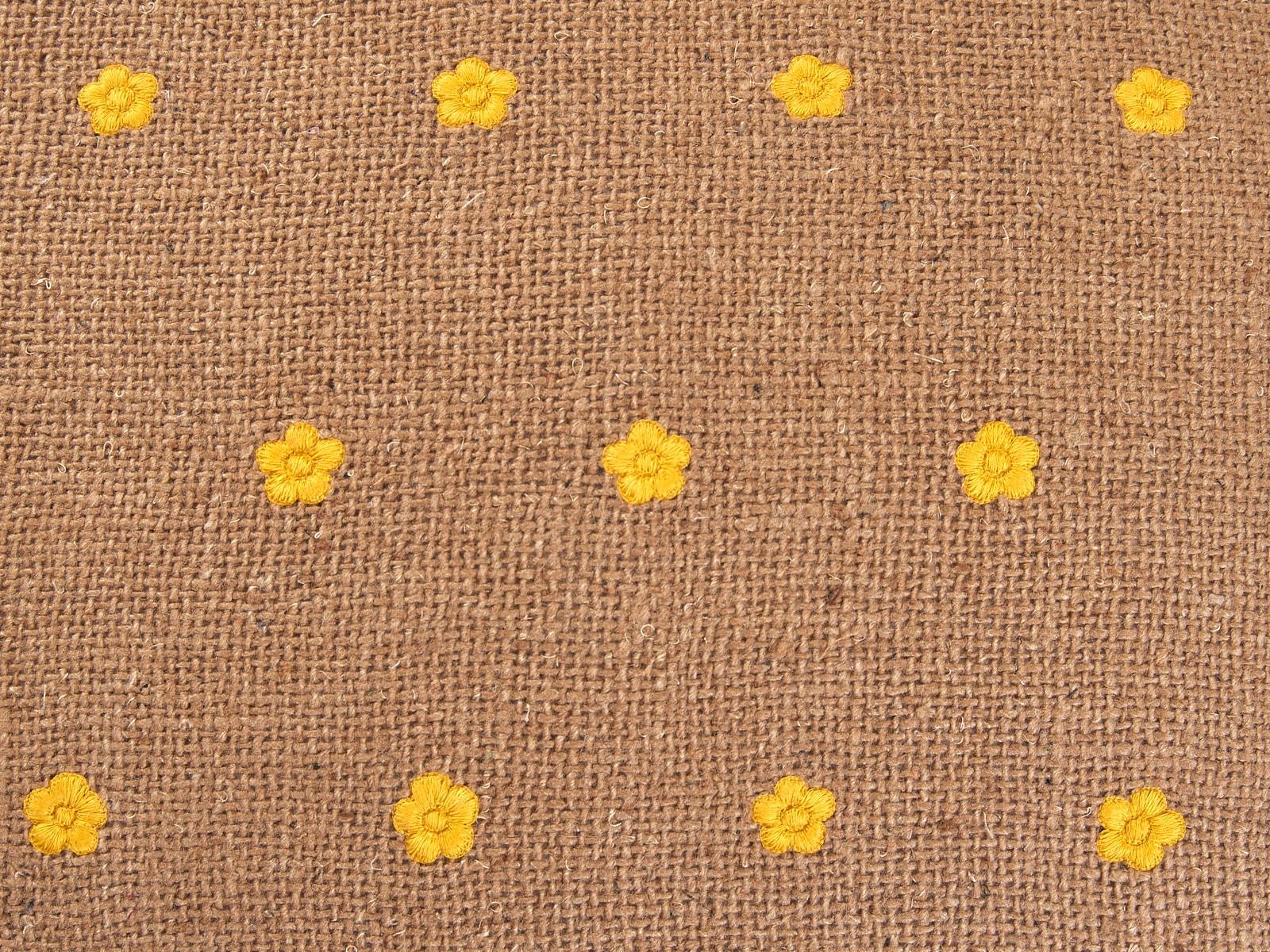 Pick your favourite colour! The sweet little yellow flowers are entirely embroidered by hand on high quality natural linen jute. 
Standard size 60 x 45 cm. Customisable in other sizes, colour combinations or fabrics on request. To visualise the