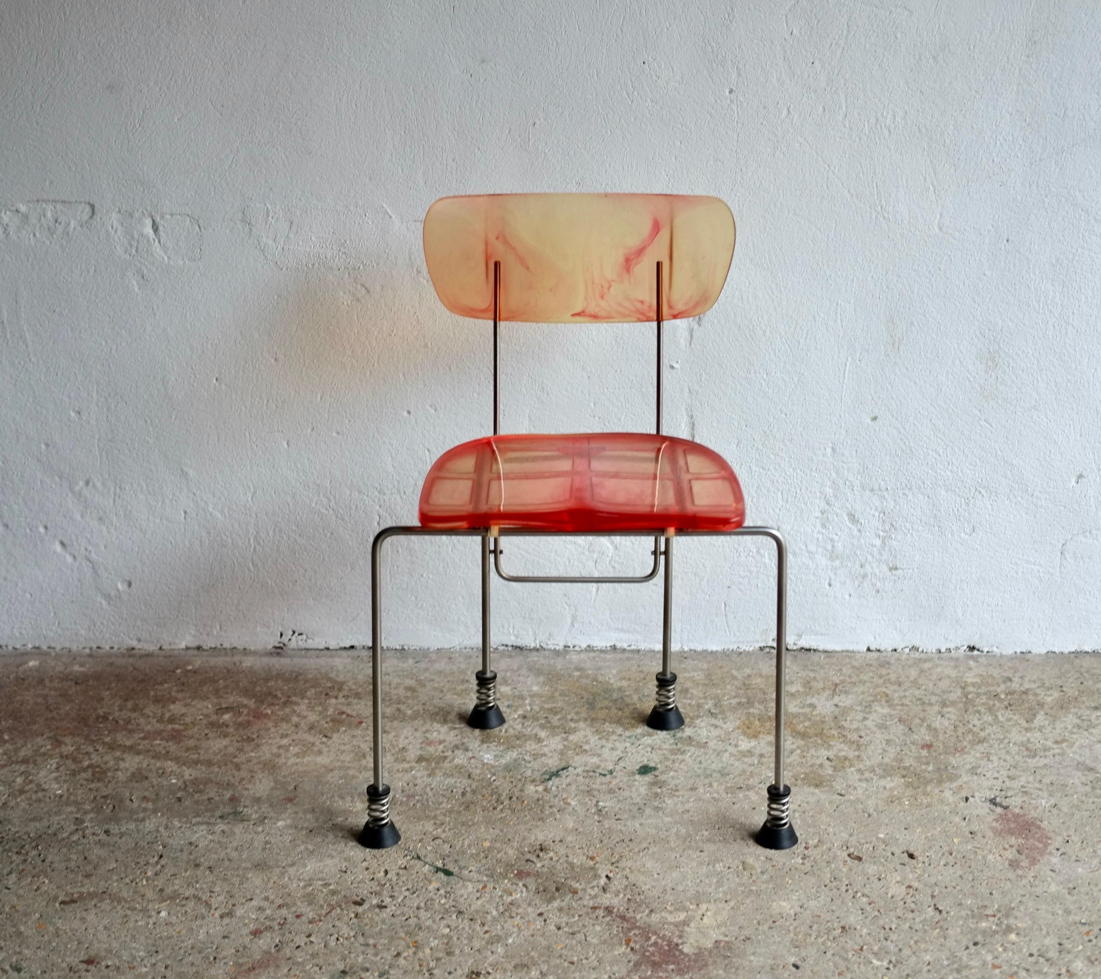 Broadway chair designed by Gaetano Pesce for Bernini, 1993.

Orange/red toned resin moulded plastic with brushed steel legs.

In very good vintage condition with no damage or missing parts.