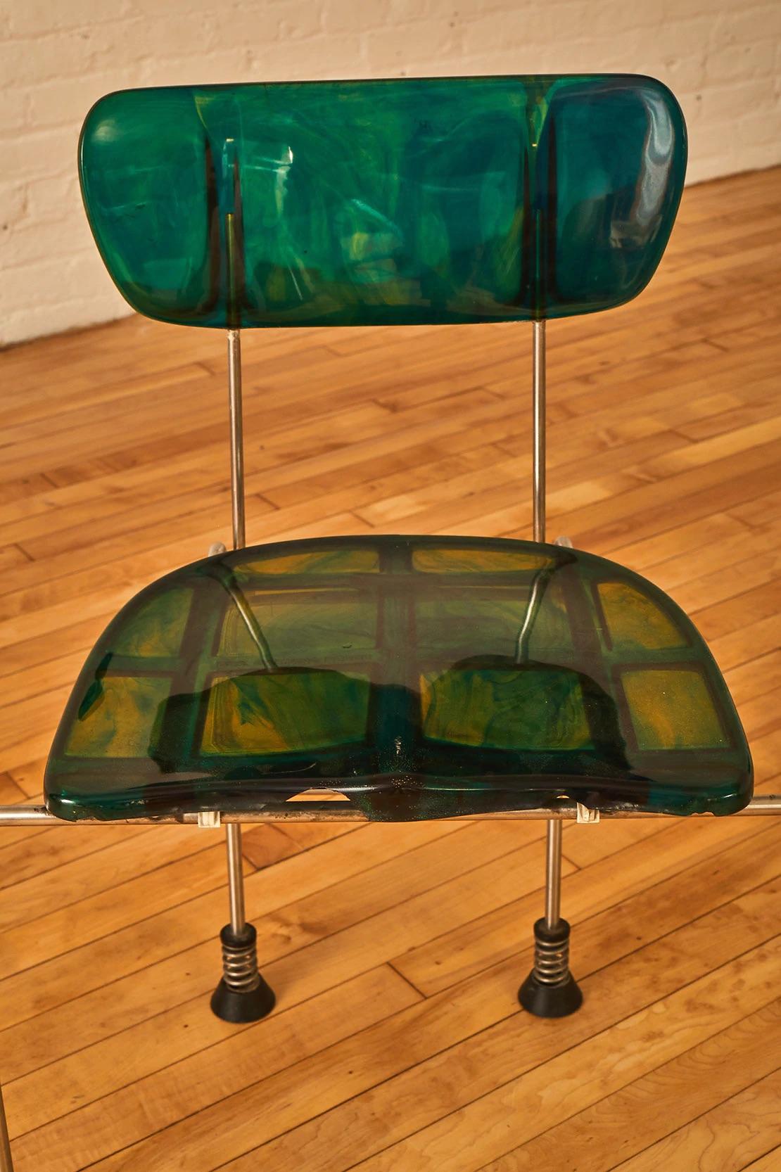 Sculptural broadway chair designed by Gaetano Pesce for Bernini. Each chair features a marble green hue.Supported by flexible and dynamic brushed steel frame. The seat and back are cast in the Gaetano's signature resin. Finished with round spring