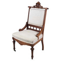 Antique Brocade-Upholstered Eastlake Parlor Chair with Casters