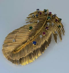 Broche plume en or 18 Carats ornée d'émeraudes, Diamants, saphirs et rubis