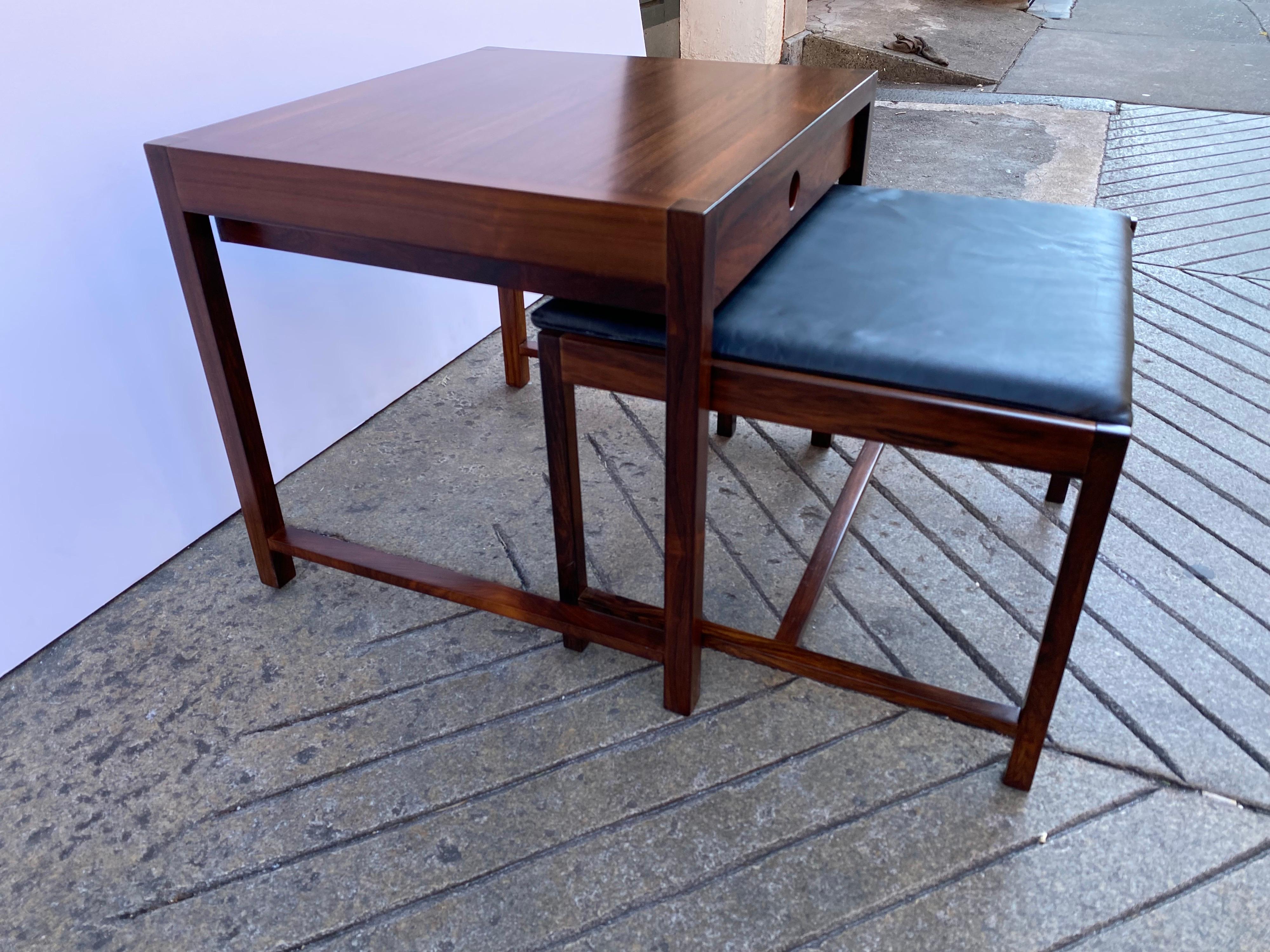 Brode Blindheim for Sykklyven rosewood end table and nesting ottoman. Beautiful and useful! Table with one pull out drawer that has been beautifully refinished. Nesting Ottoman fits easily under the Table. Ottoman measures 21 x19 and is 15