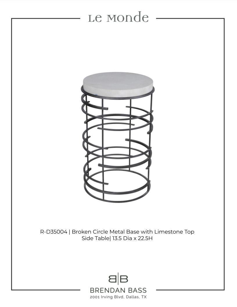 Side table designed by Brendan Bass. Round circle steel base with limestone top. Hand crafted in Dallas by local artisans.

