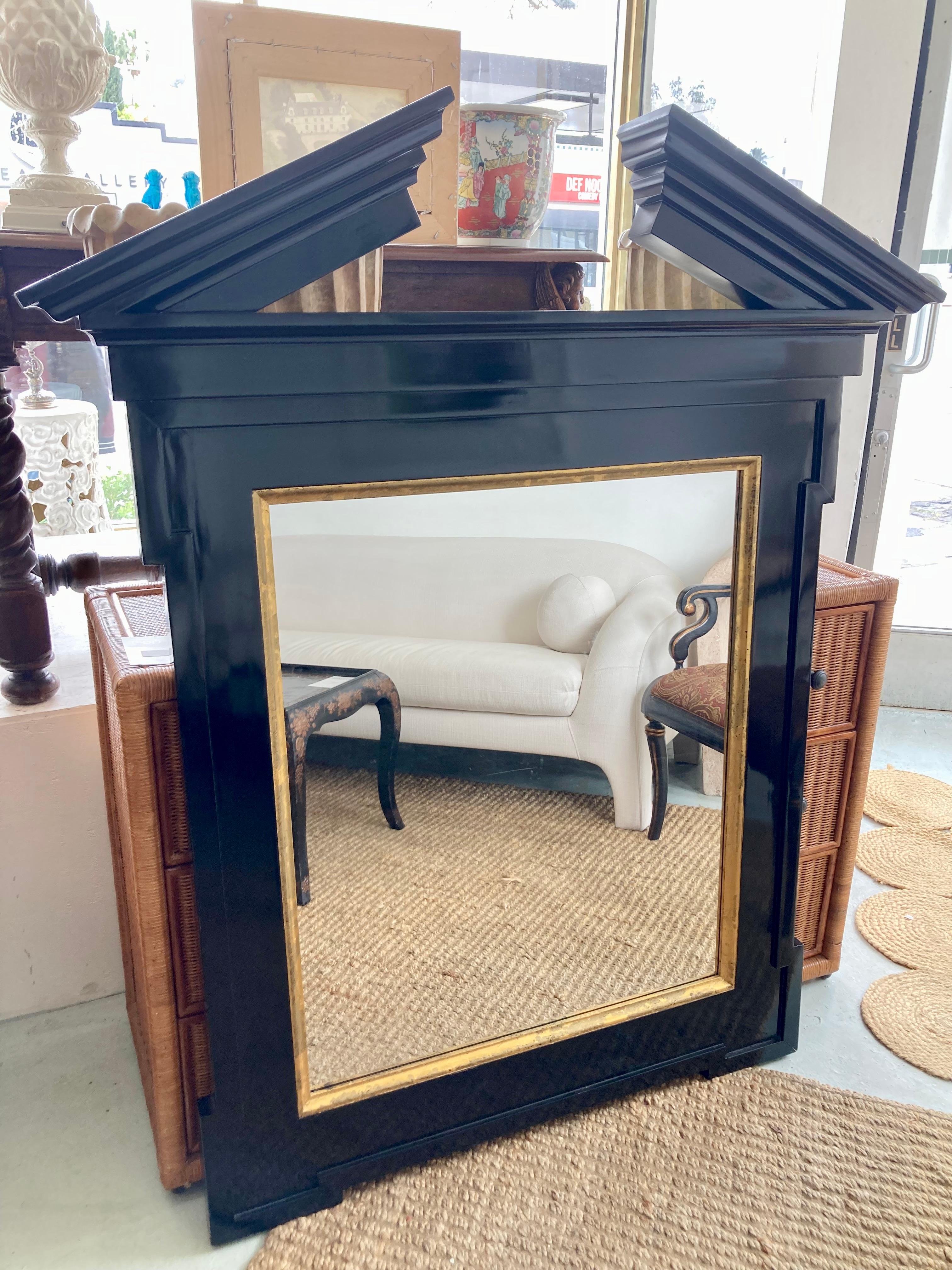 Broken pediment mirror by John Hutton for Donghia in custom size and black gloss finish with gilt details. Gorgeous color combination with black and gold. Add some classic architecture and drama to your interiors or design project.
