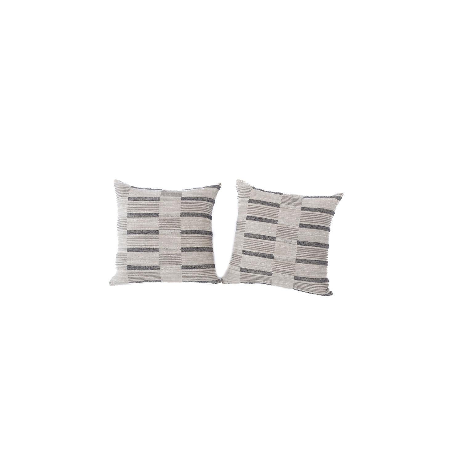 These new down filled pillows are crafted from a luxurious textured slub wool & linen blend textile.  Cream, warm grey and charcoal tones in a sophisticated broken stripe motif.  conceptualized and created by the danish teak classics design unit.