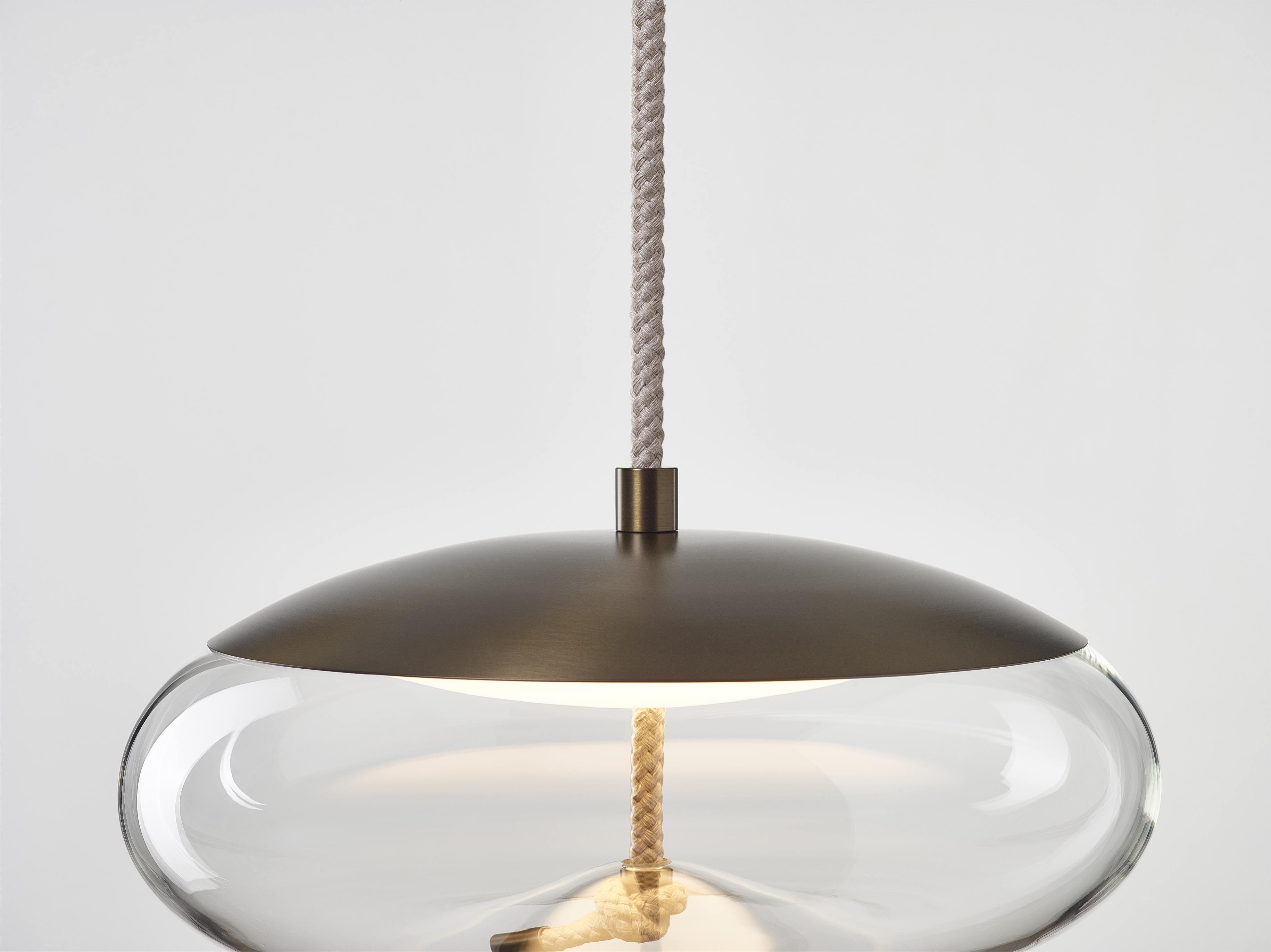 Brokis 1017 Knot Disco large suspension lamp in smoke gray transparent glass with brass metal parts and black cord. It hangs 50cm from the ceiling to the bottom of the fixture. It can be made shorter but not longer. Dimmable 1-10V and is for the
