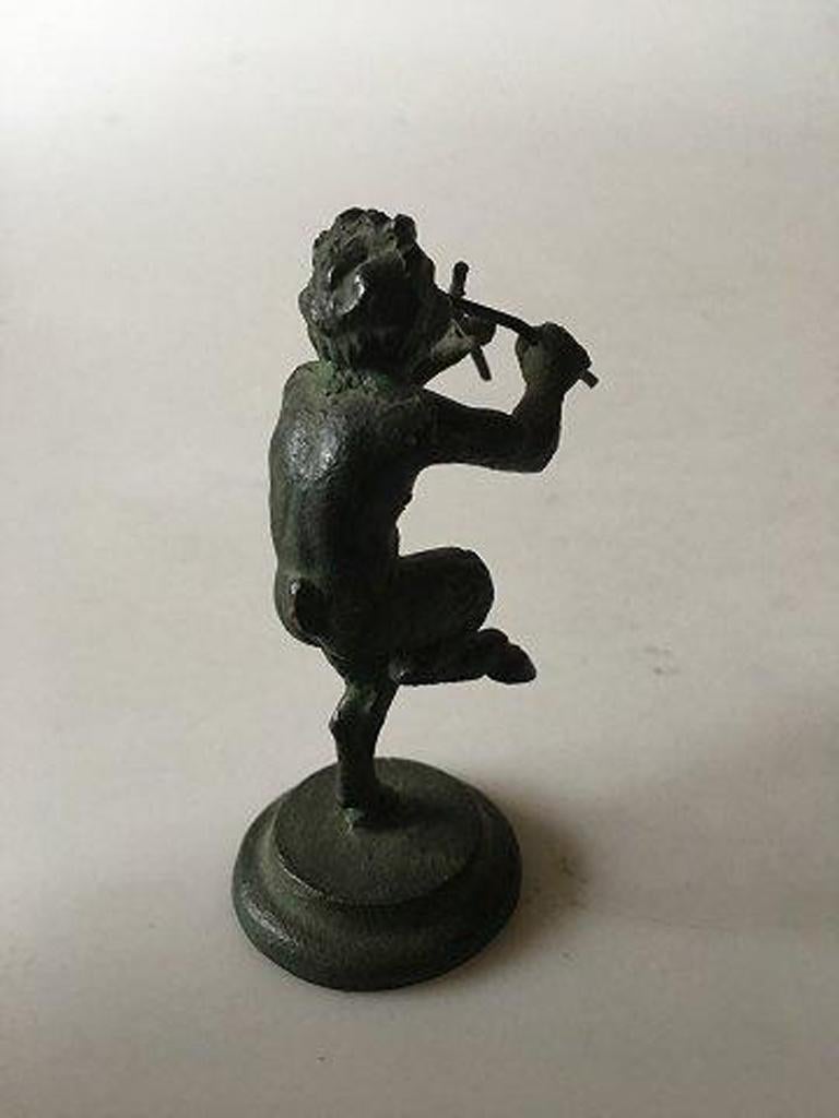 Bronce figurine of a pan playing flutes. 

Measures 8,5cm and has a nice patina and is in good condition.