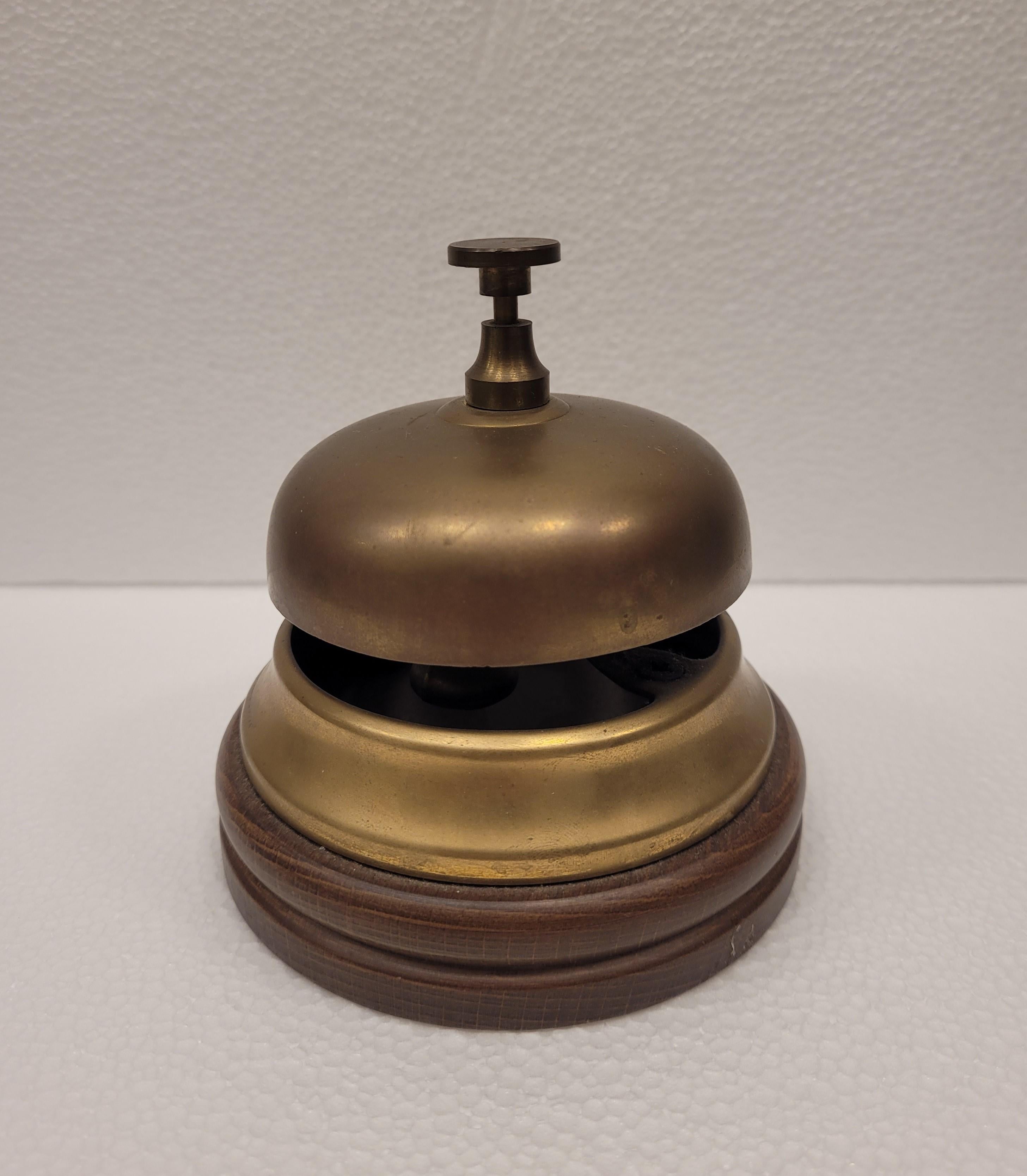 A very good idea for an original present!!!!! A Classic reception style bronze bell with oak base. Bronze with golden lustre and polished oak wood.

It is a delicate piece that fuses precision with a refined aesthetic sense. The elegant design
