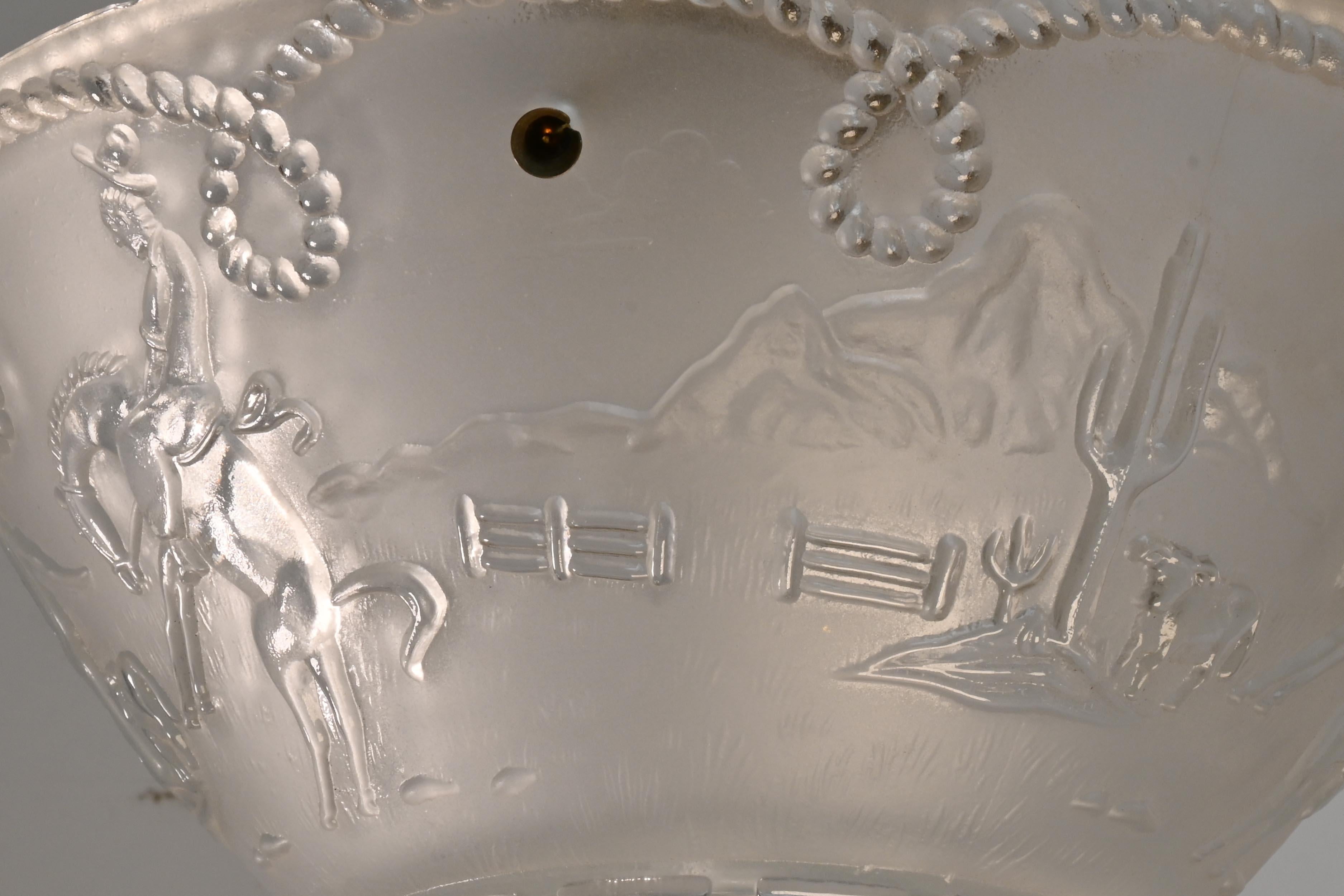 Western themed Bronco Riding Cowboy Molded Glass Flush Mount

Two Available / Priced Separately
AA# 61159

This low profile 3 chain flush mount with mold glass shade with bronco riding cowboy, range scene that includes cactus & cattle called