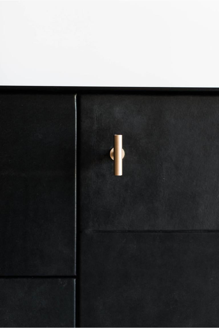 The Bronson Sideboard is handmade locally in Los Angeles, California. The unique design of the piece draws its original aesthetic through the combination of classic metal casing and the refined leather doors. The industrial steel casing, a staple of