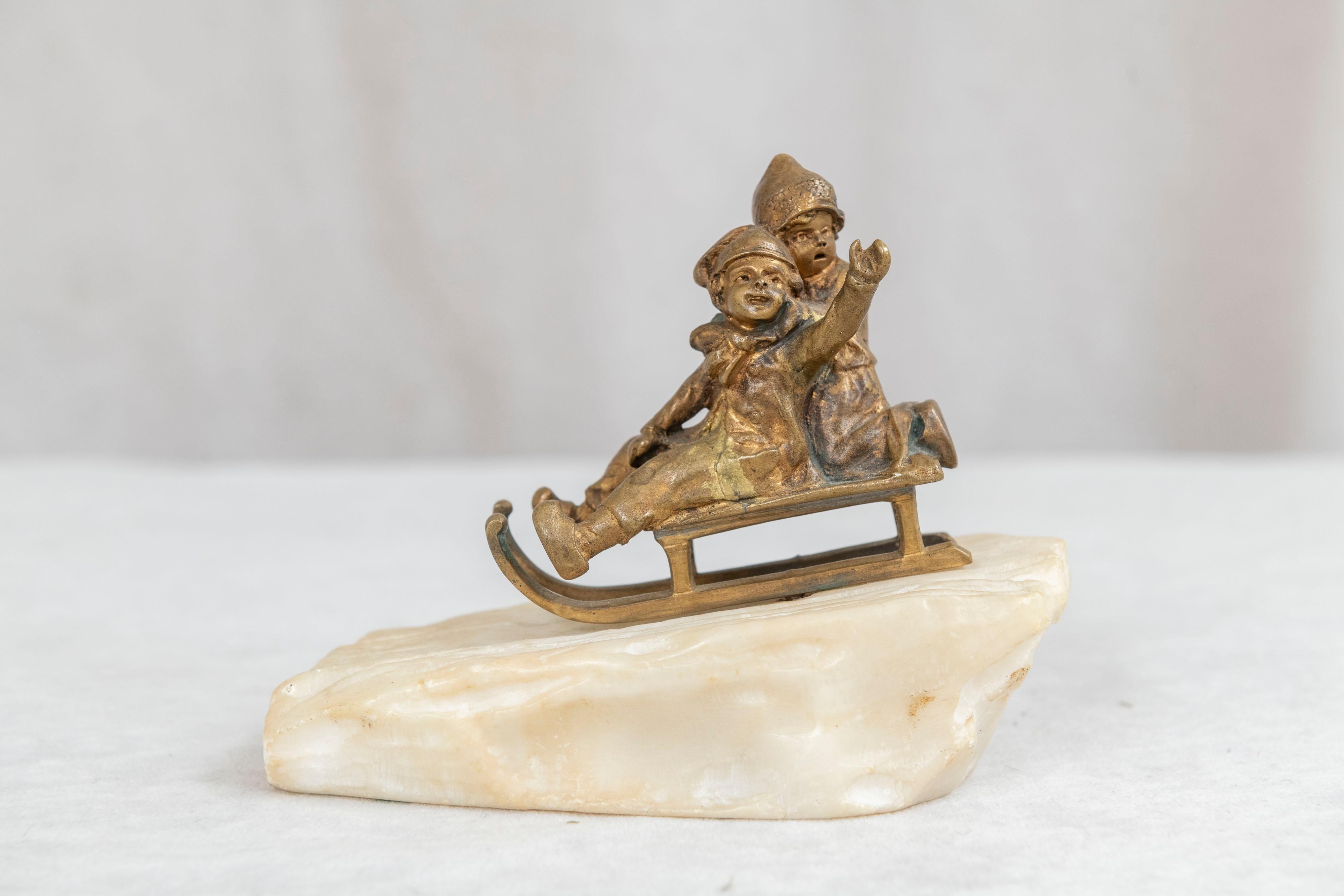 19th Century Bronze, 2 Young Children Riding on Sled on Carved White Marble Base ca. 1895 For Sale