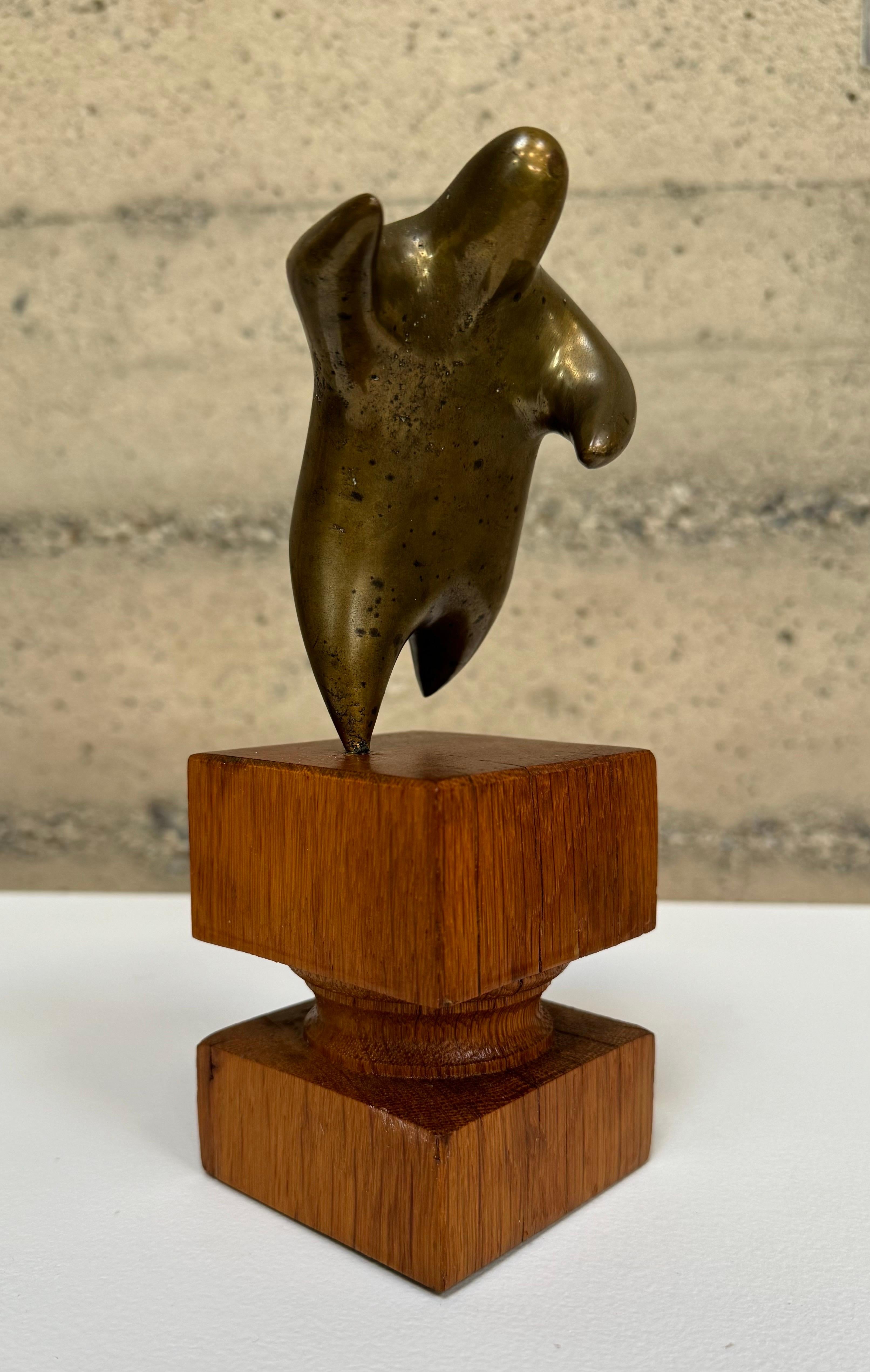 Figurative abstract sculpture in bronze on a hardwood base. A whimsical form from the estate of Warren Davis, who was the owner of the Vintage Antique Bank in Petaluma, California. Warren was know for his wide ranging interests in the art world and