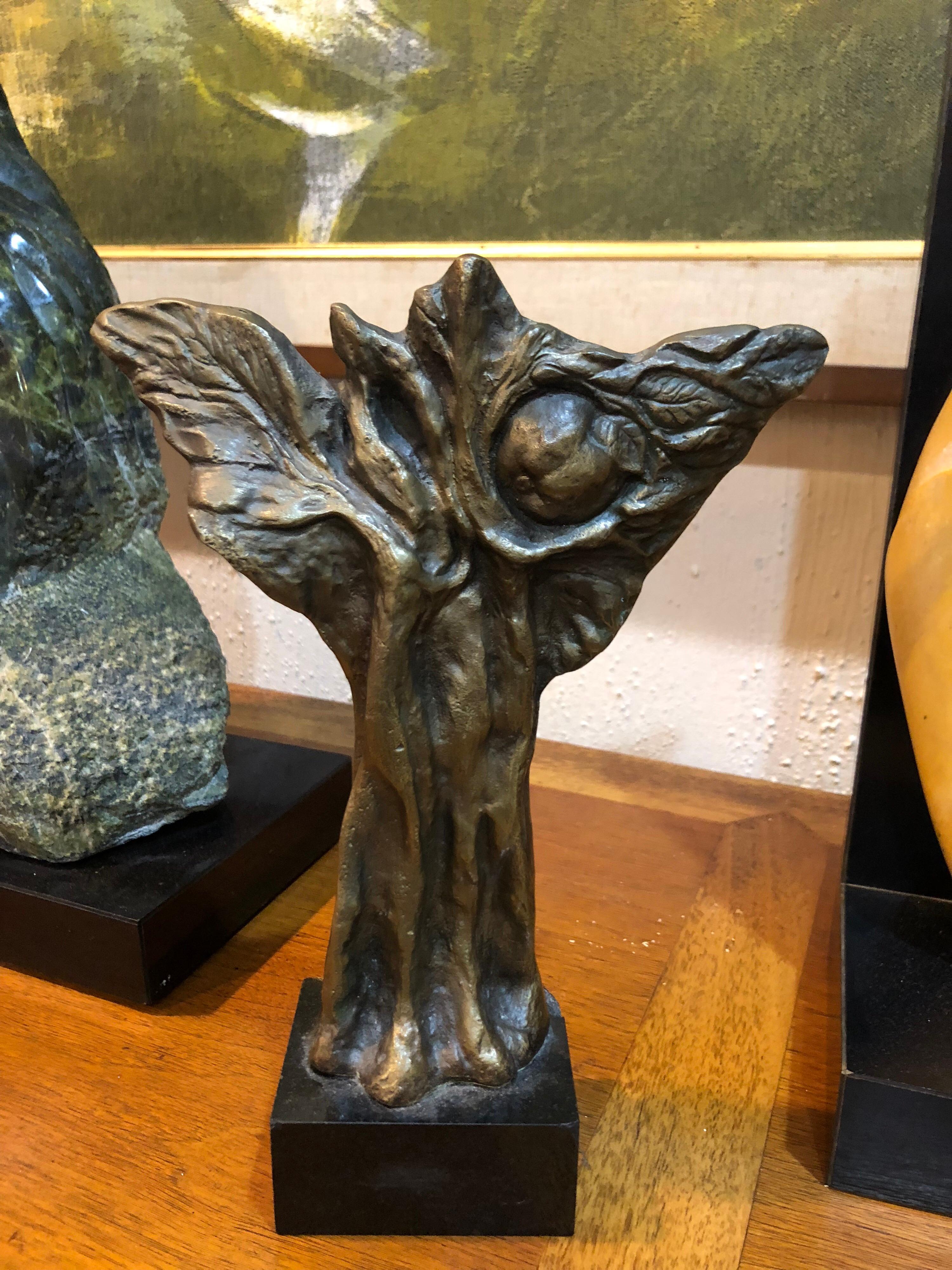 Bronze abstract sculpture of an apple tree. Arts and Crafts style bronze on a black marble plinth. Human looking feet sprout into a wing like tree structure with a hidden apple. Price is firm . Final Sale . Please request a parcel shipping quote