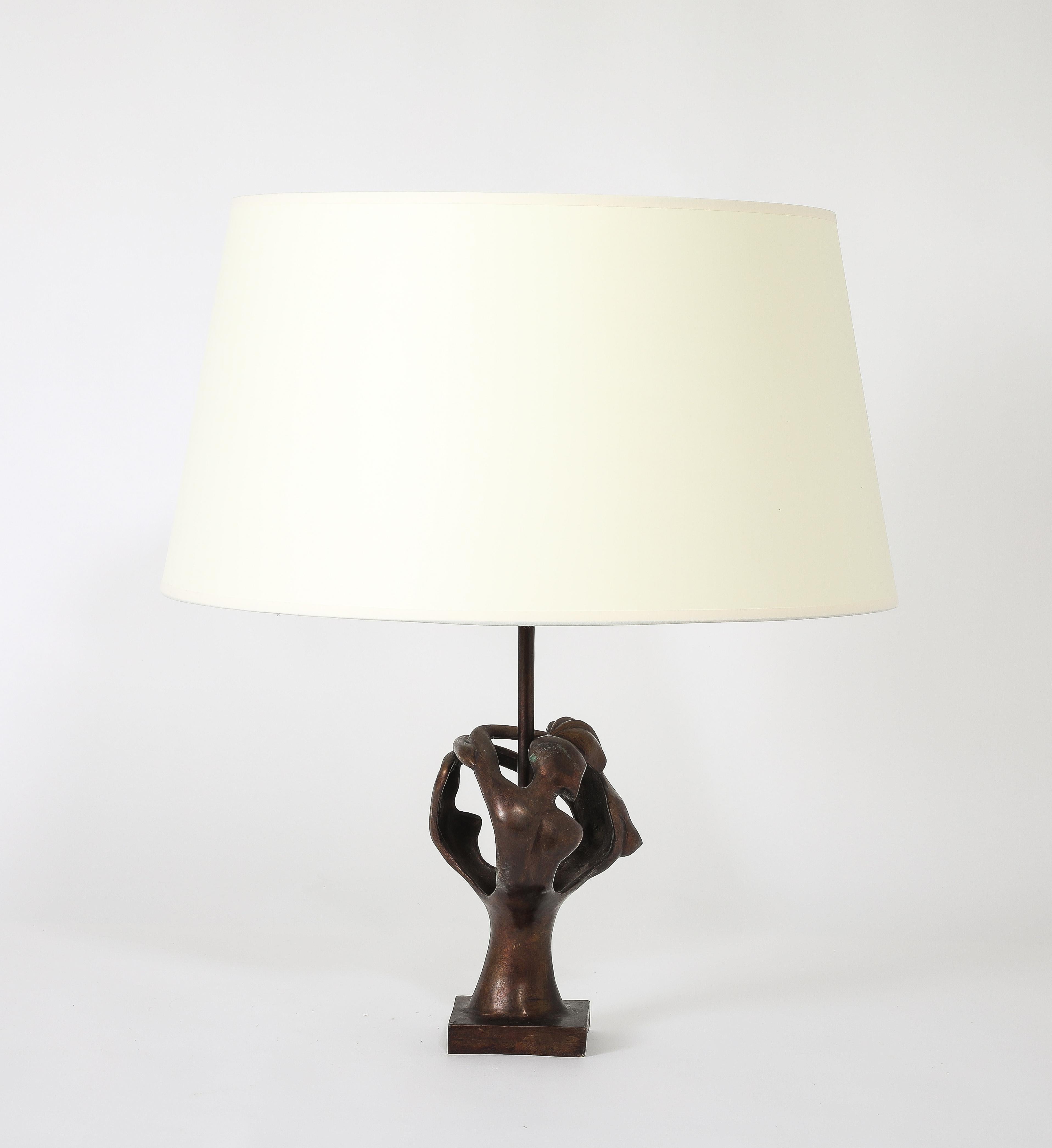 An Abstract bronze lamp representing a couple embracing.