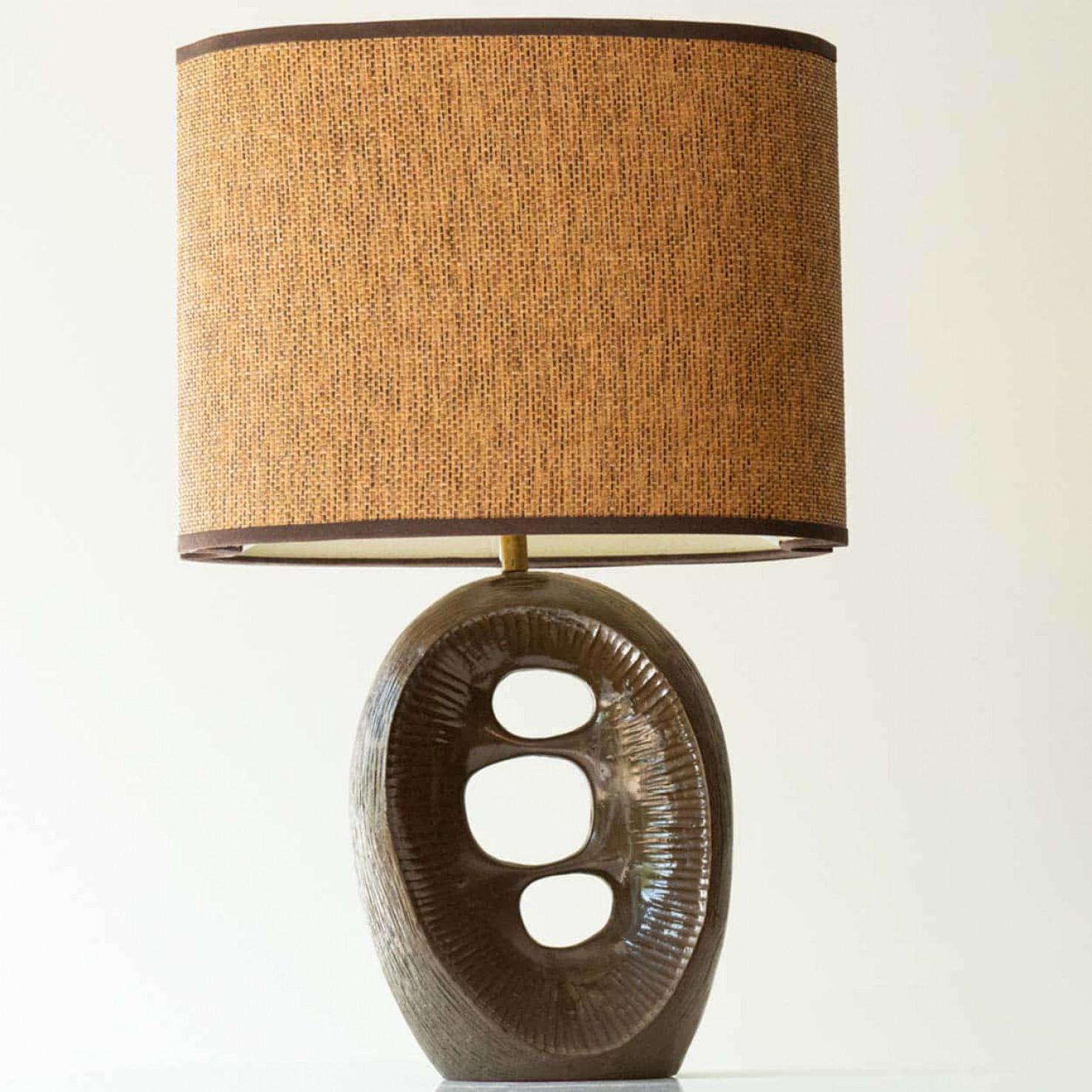Beautiful ceramic table lamp, UK  1960s.

This lamp base brings refined elegance and rich visual appeal to any interior. With its abstract shape, it offers a unique presence. 

This base with dark brown tones fits perfectly with the warm custom made