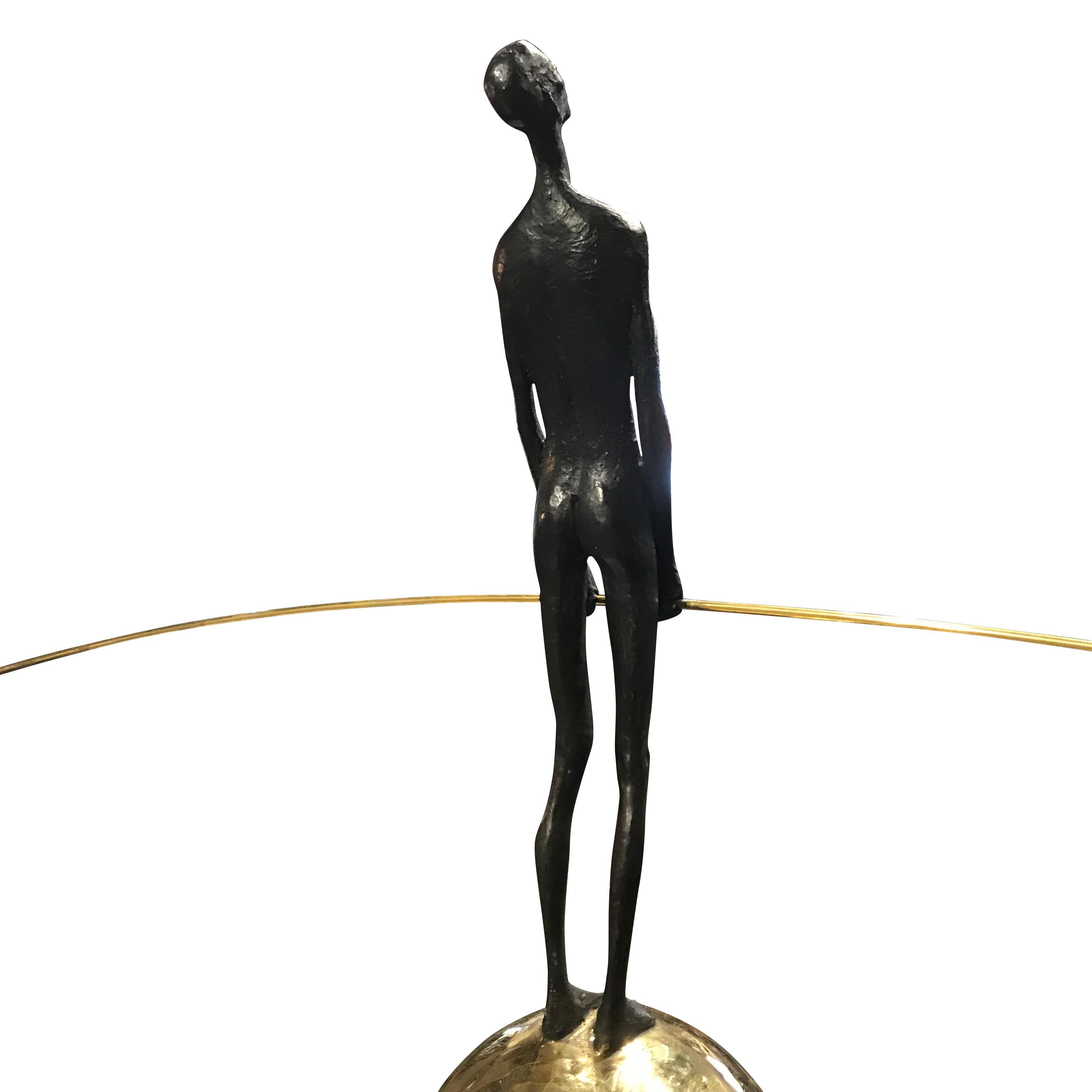 Contemporary German bronze acrobat standing on bronze ball mounted on wood pedestal
Statue stands on wood pedestal
Pedestal measures 6.5