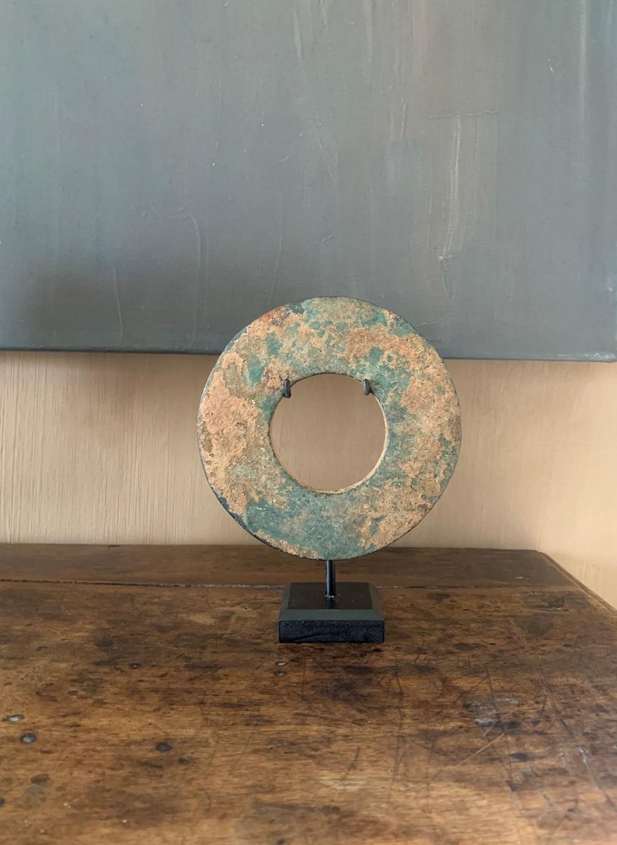 A large circular bronze votive circa 1000 b.C. The tapering profile lending a the object a elegant form. 

Circles have been found in many ancient cultures. The Chinese for example used it to symbolise heaven in combination with square forms