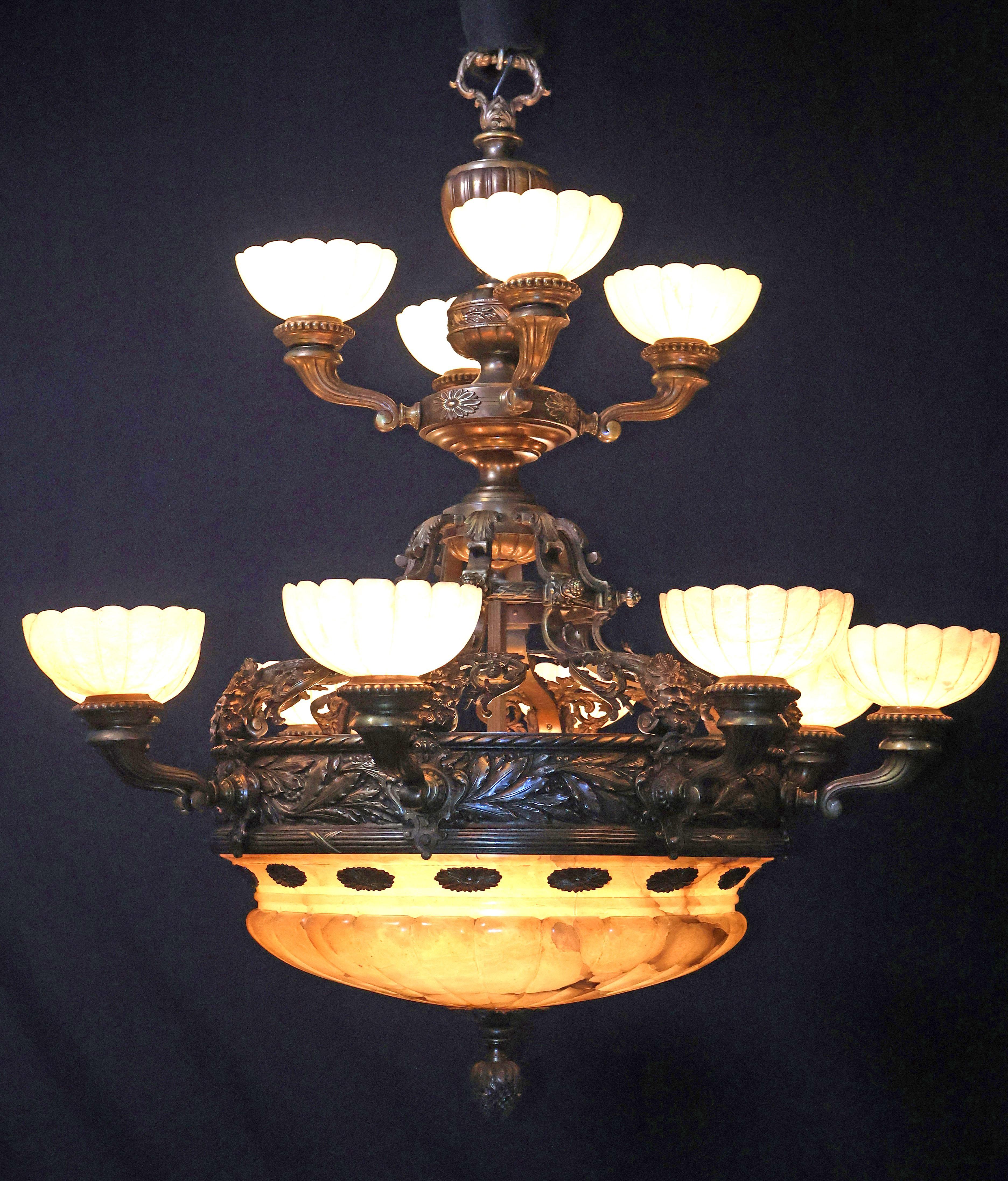 Uno squisito lampadario in bronzo di grande qualità con cupola e paralumi in alabastro intagliati a mano. Francia, circa 1920.
Dimensioni: Altezza 47
