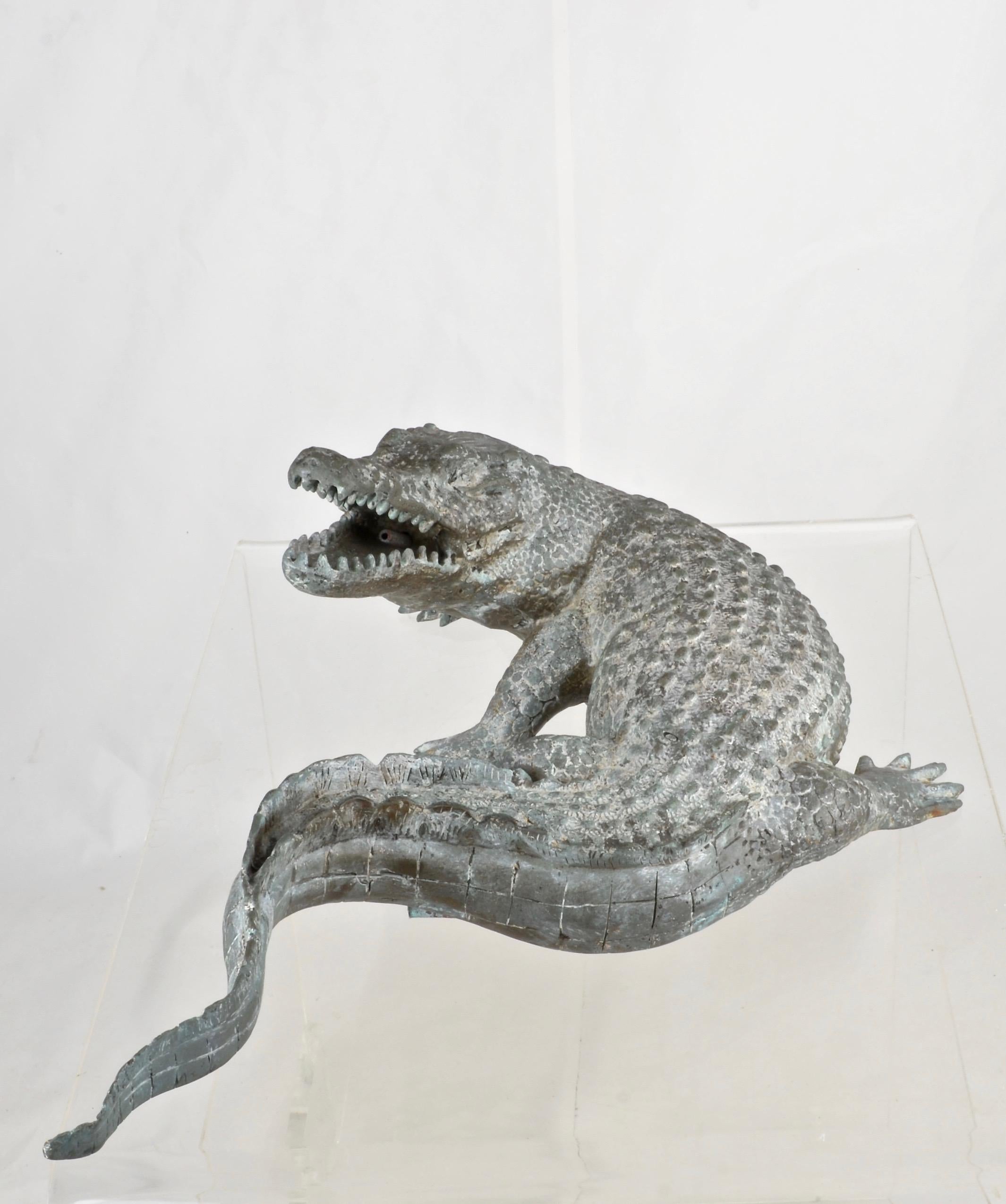 A whimsical water feature in a finely crafted alligator form. Intake under the tail and output in open mouth. Perfect patina. Nice size and that face!