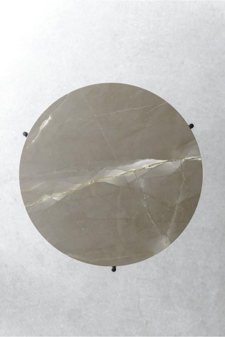 La table basse Bronze Amani vient compléter notre série de tables basses en marbre. Le plateau en marbre Bronze Amani arbore des tons terreux et des veines plus claires et variées qui se détachent sur le fond de la base en acier noir mat. Les