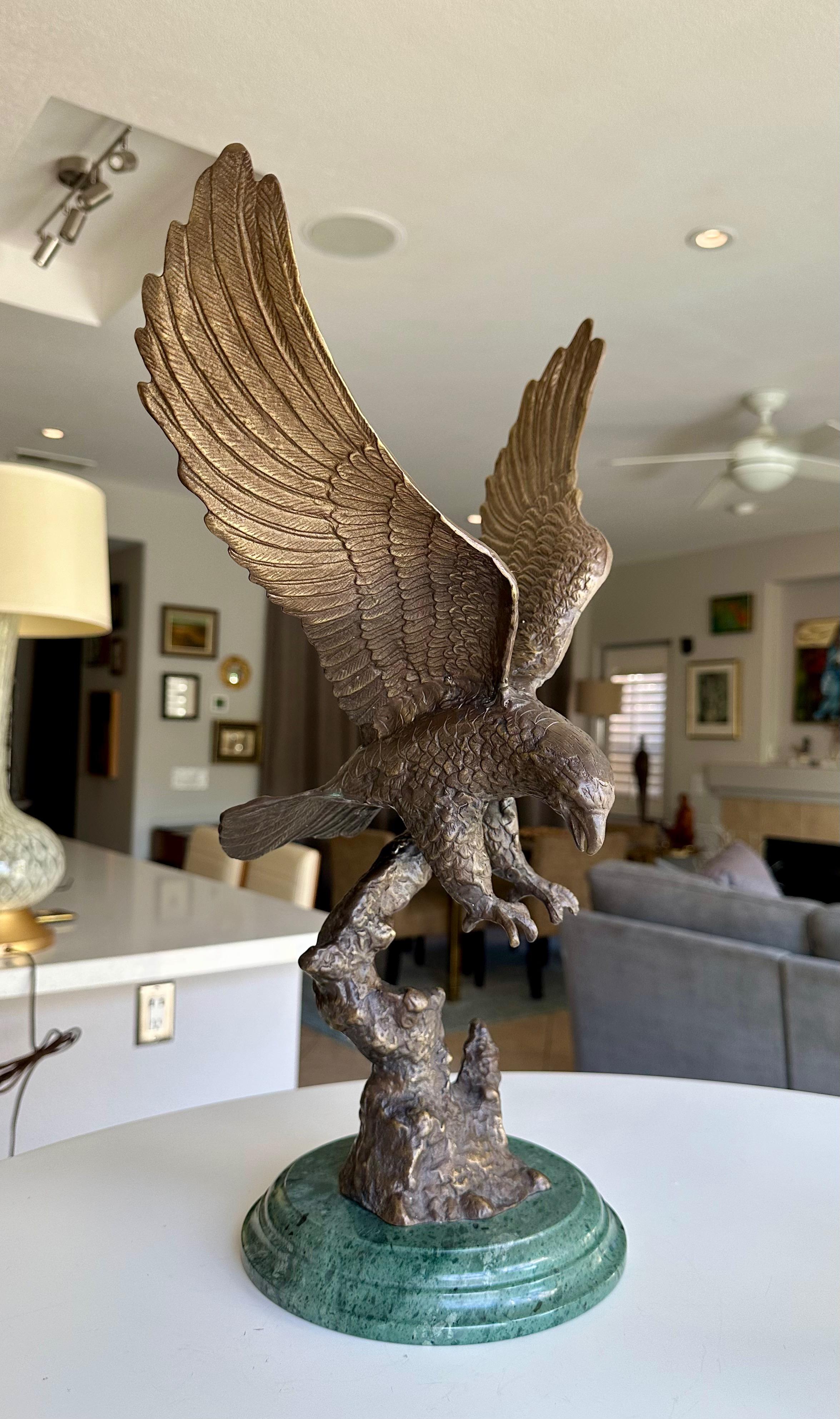 Bronze eagle (after Edward Chope) on a marble base, circa late 20th century. The bronze sculpture depicts a majestic bald eagle with its wings fully spread open, soaring down to catch prey with its talons. 