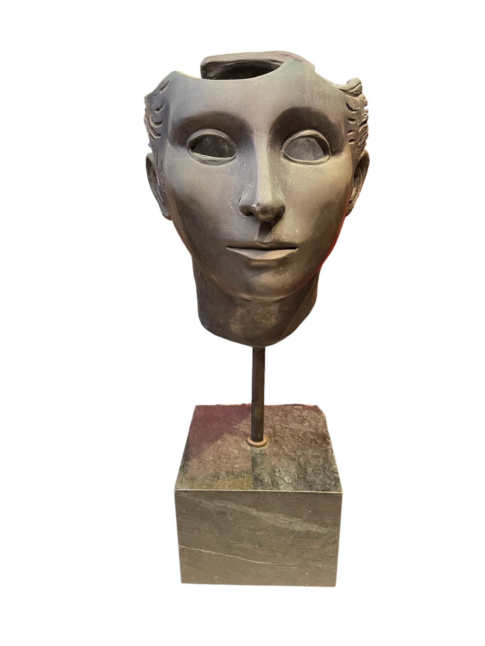 This is a bronze anatomical sculpture of a head and face of a human being made by Alfonso Arana (1927-2005) . He was born in New York City from a Puerto Rican mother and a Mexican father. He studied art in Mexico at the Atelier de Jose Bardasano, at