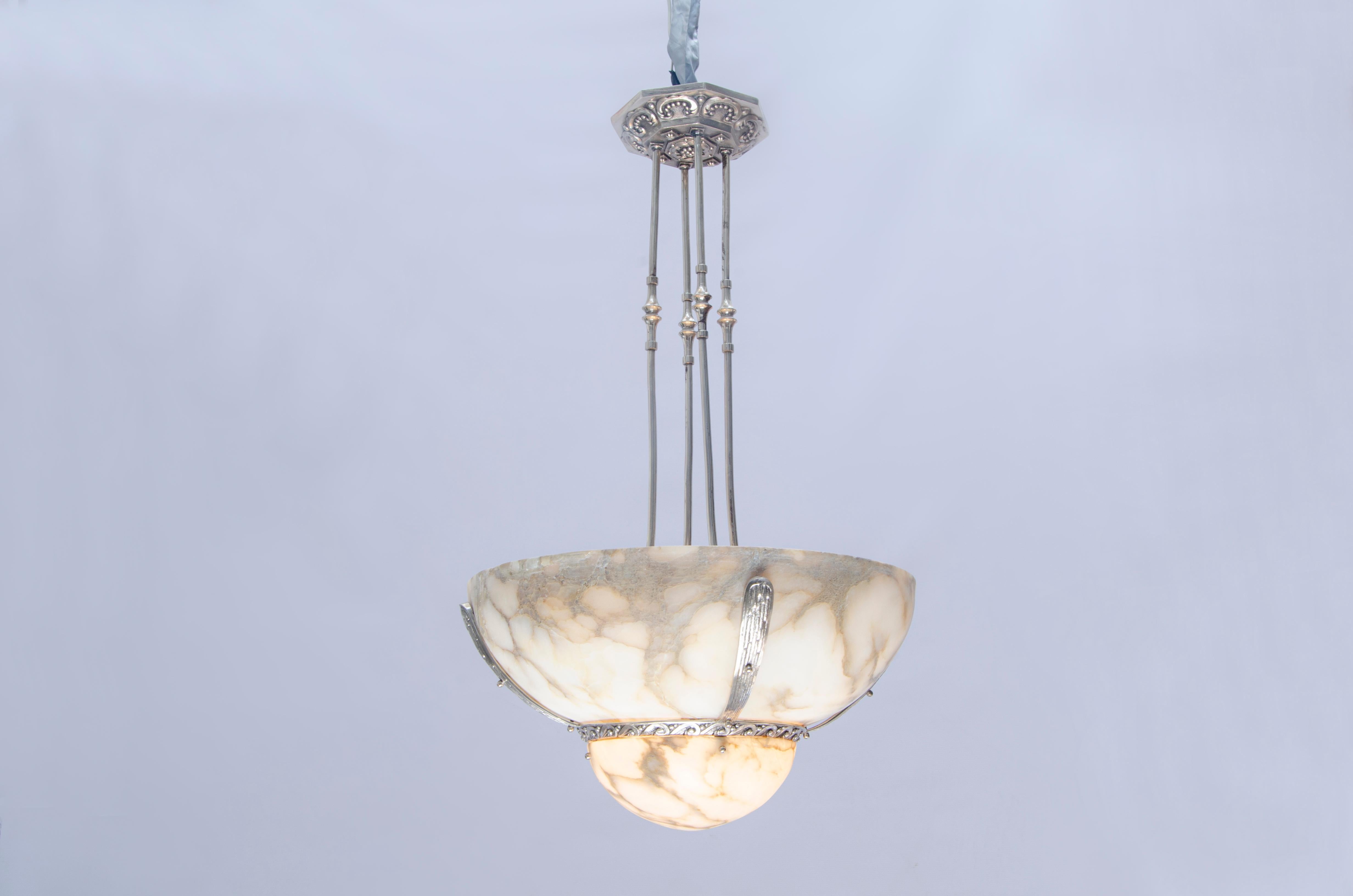 Bronze and alabaster Art Deco hanging light. Silverplated structure and canopy with alabaster shades.

France, CIRCA 1920.