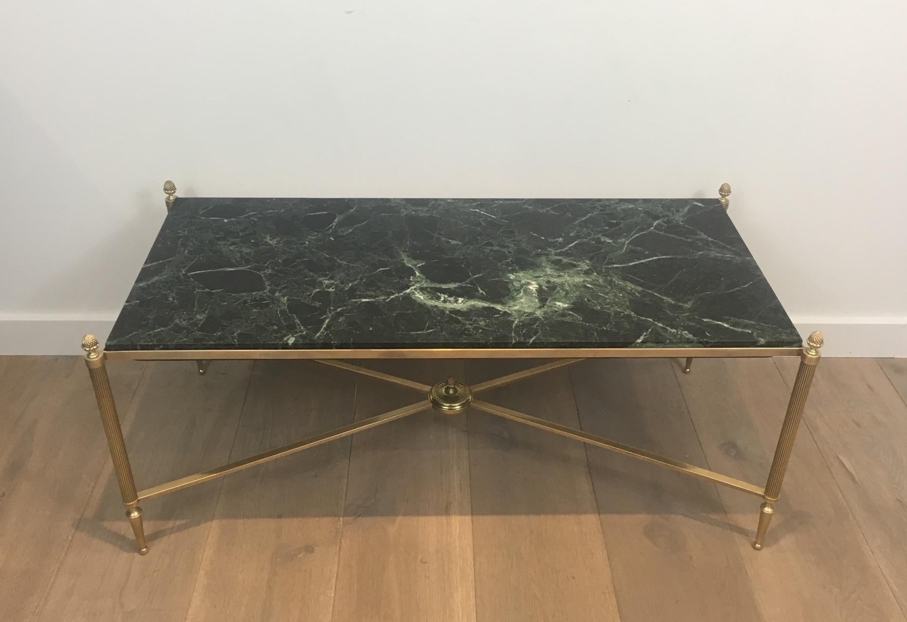 This beautiful neoclassical bronze and brass coffee table has a nice green marble top. This cocktail table is French and attributed to Maison Bagués, circa 1940.