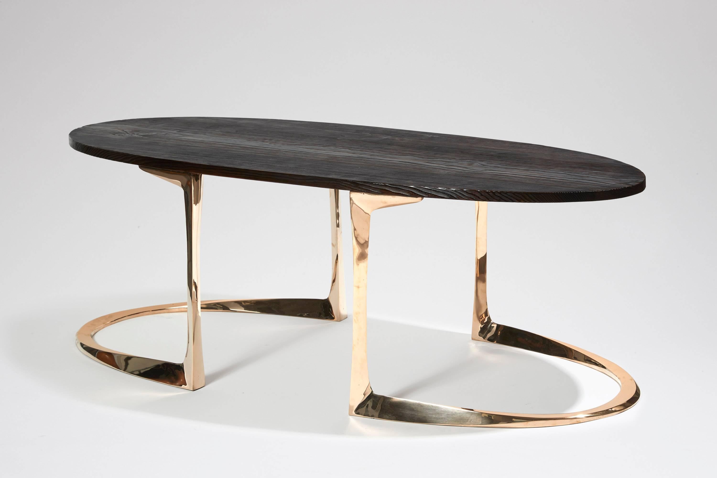 A polished and varnished bronze coffee table with a burnt pinewood oval top, the base with the Anasthasia Millot's signature.
Designed and executed in 2017 with burnt pinewood exclusively with WH Studio.

 