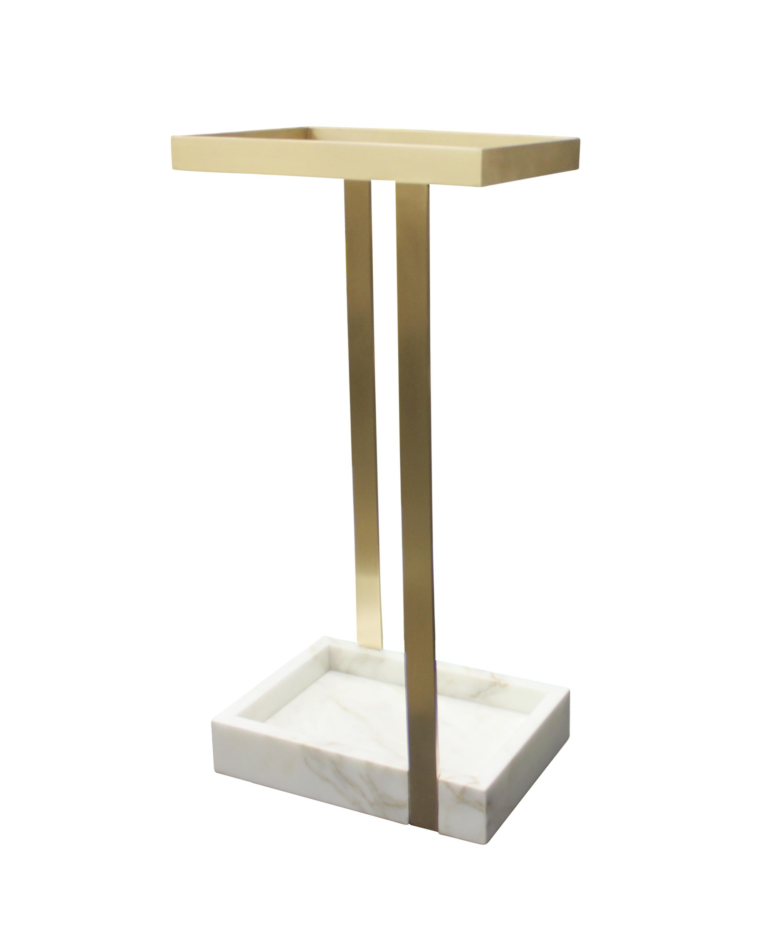This subtle yet striking umbrella stand creates an arresting focal point in a foyer or vestibule. Shown here in satin bronze with calacatta gold marble, the piece is handmade to order in New York City and can be specified in any number of custom