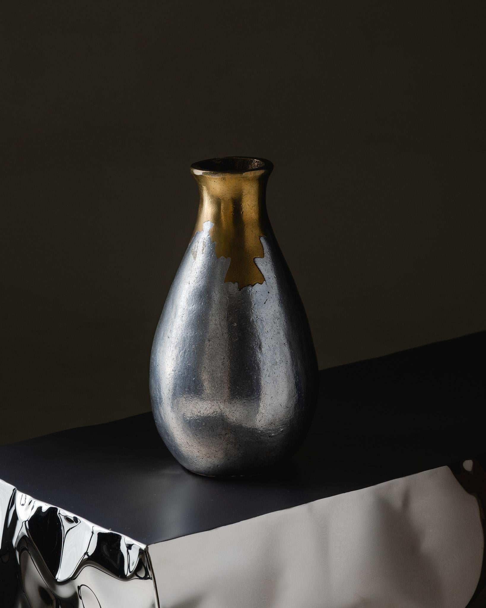 Polished Bronze and Cast Aluminum Vase with Fused Effect, designed by Philippe Jean for Arpège in the 1970s. French work. Slender ovoid shape with a narrow neck, hammered surface with shifting reflections blending silver and gold tones. Excellent