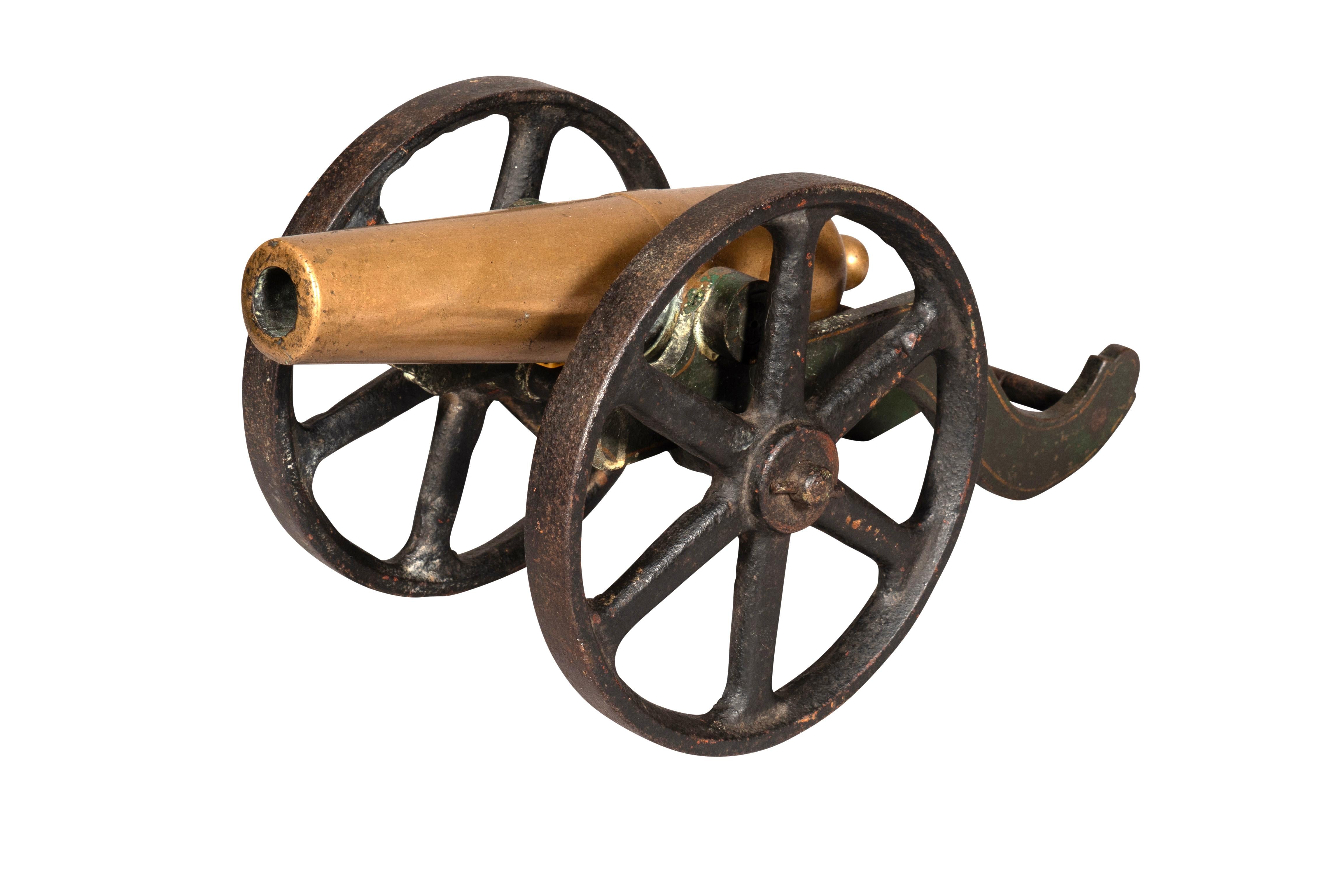 With bronze cannon mounted on a cast iron base with wheel carriage.