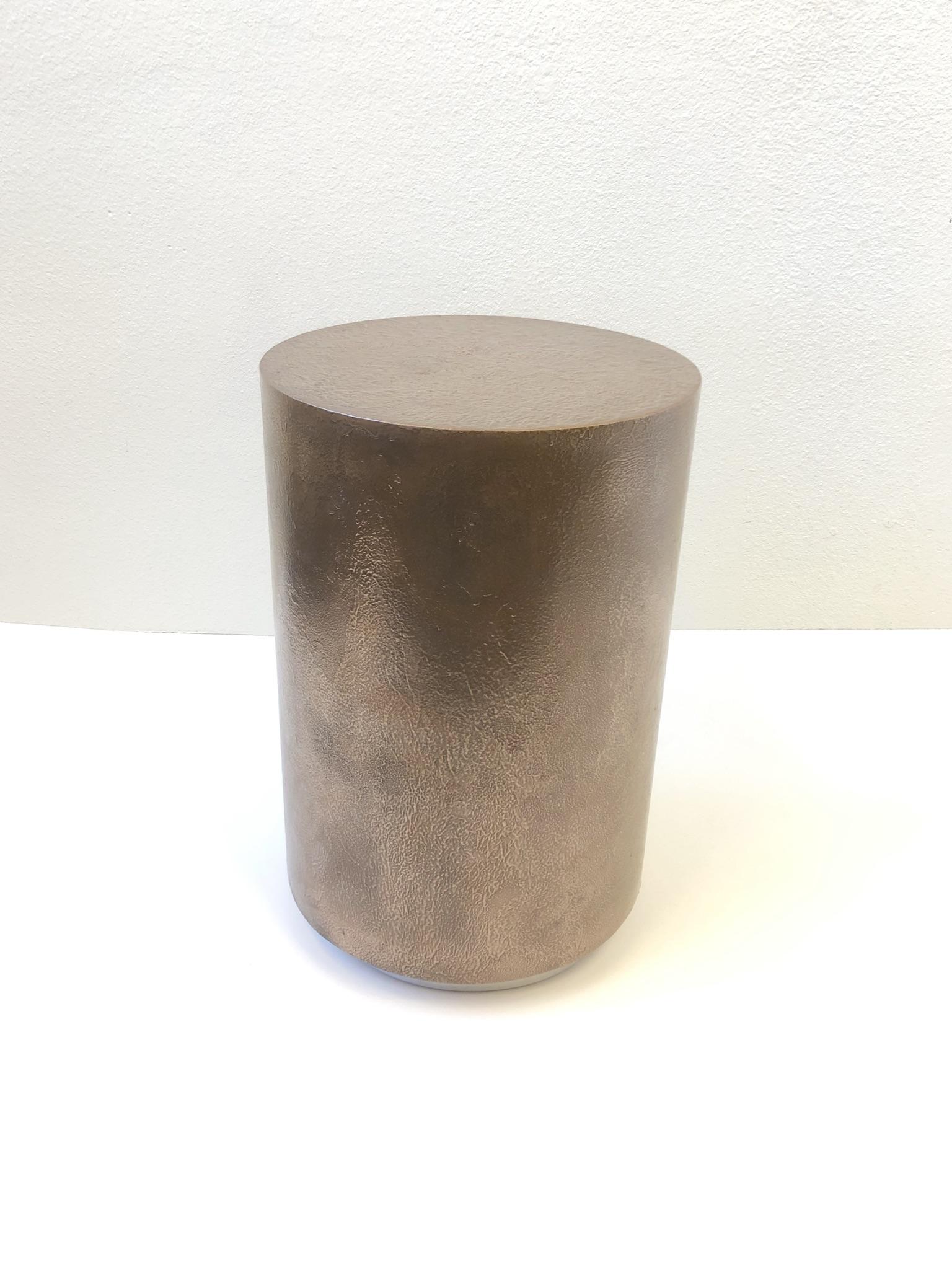 A 1980s drum occasional table by Steve Chase. The table is constructed of wood with a custom texture aged bronze finish and a polished chrome base. 
Measures: 23.25” high 15.25” diameter.