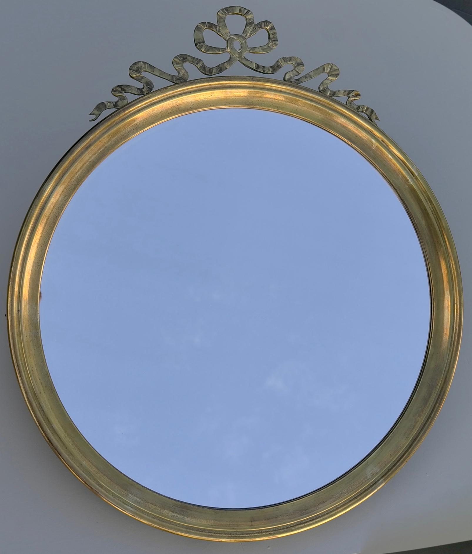 Bronze and copper round wall mirror with elegant knot, France, 1940s.