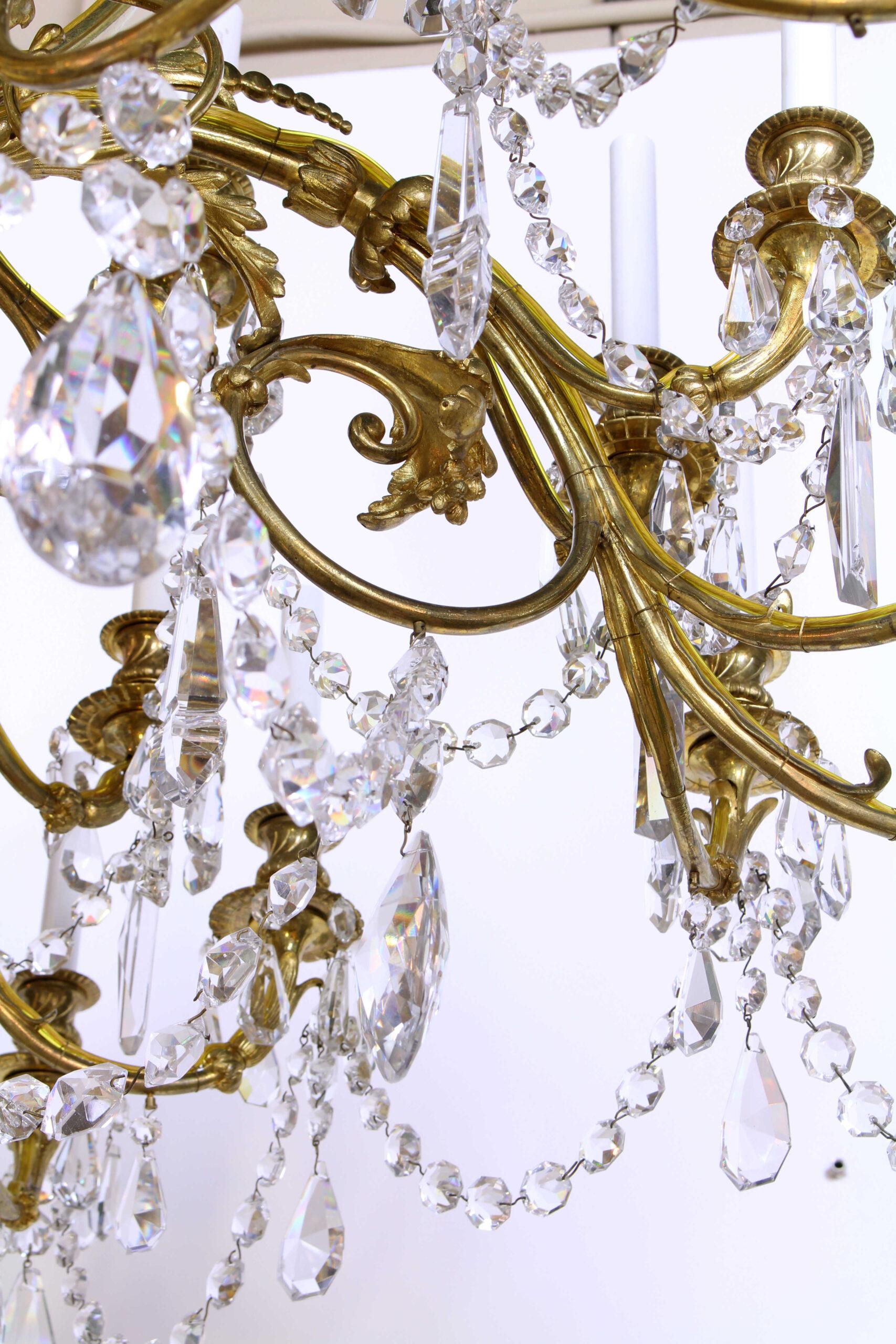 A magnificent late 19th century gilt bronze and crystal chandelier. 36 lights on alternating curved foliate arms. Central stem has greek key design seen on some similar styled Baccarat chandeliers of the late 19th Century. High lustre crystals hang