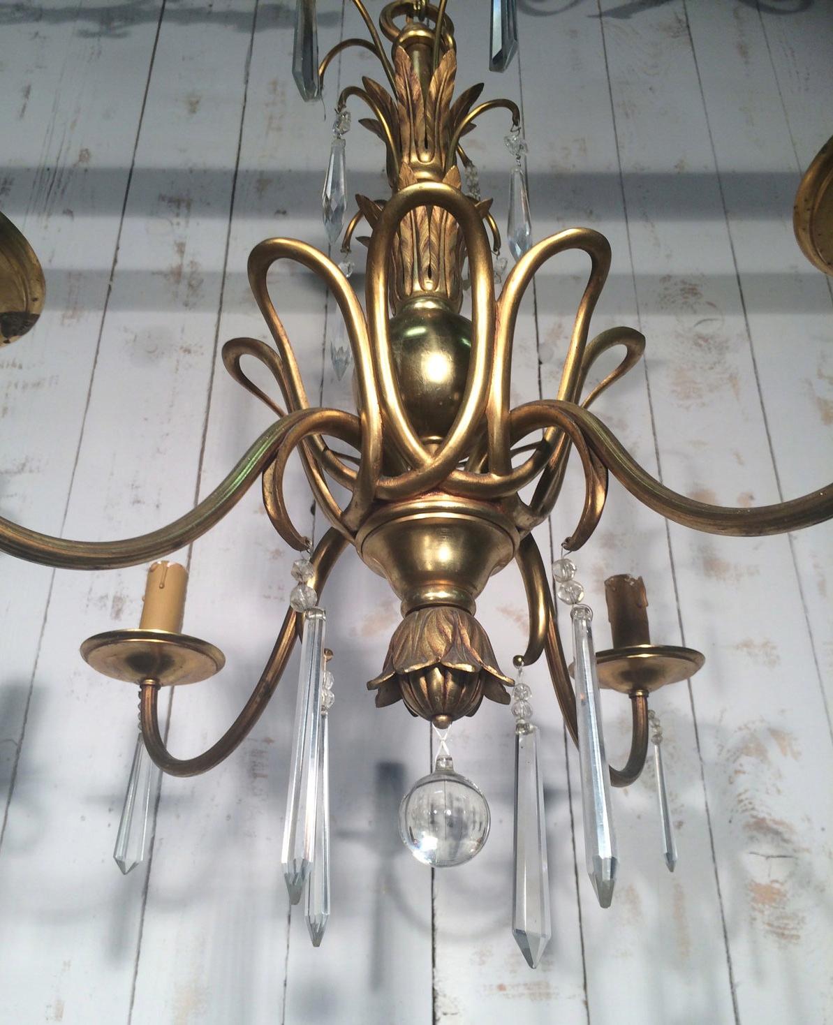 This chandelier is made of bronze and crystal. It has a very nice shap and is very elegant. This is a French work in the style of Maison Baguès. Circa 1940.