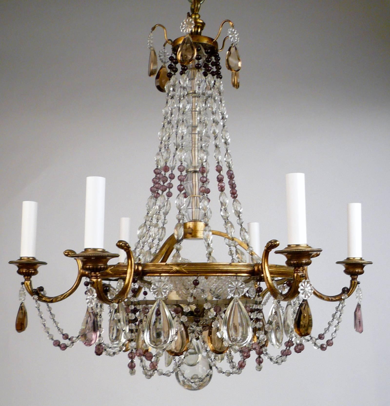This fine quality fixture features neoclassical motifs, and is hung with clear, amethyst, and topaz colored crystal prisms.
  