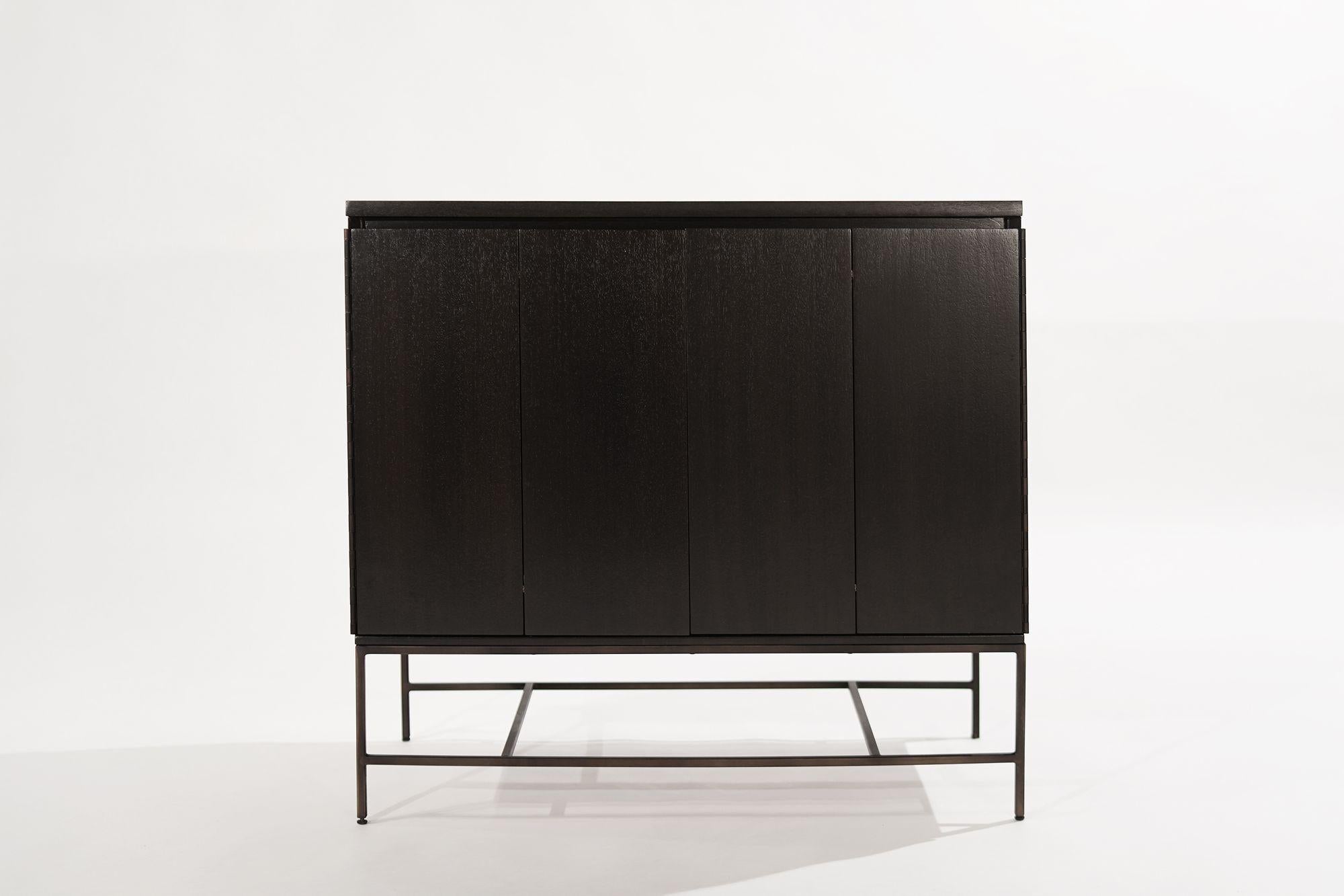 A classic cabinet designed by Paul McCobb for his Calvin Group line of furnishings, circa 1950-1959. Featuring bi-fold doors which open up to reveal four drawers, providing ample storage space. The mahogany case has been completely restored and