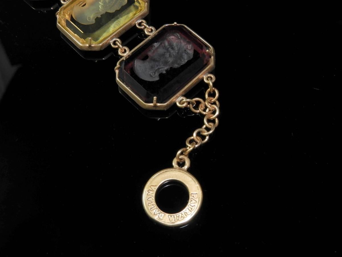Particular bracelet with engraved Murano glass depicting woman face, it'is in pure bronze and made in Italy.  To fix the stones to our jewels, according to the Italian goldsmith's tradition, we use the technique of setting with griffes giving the