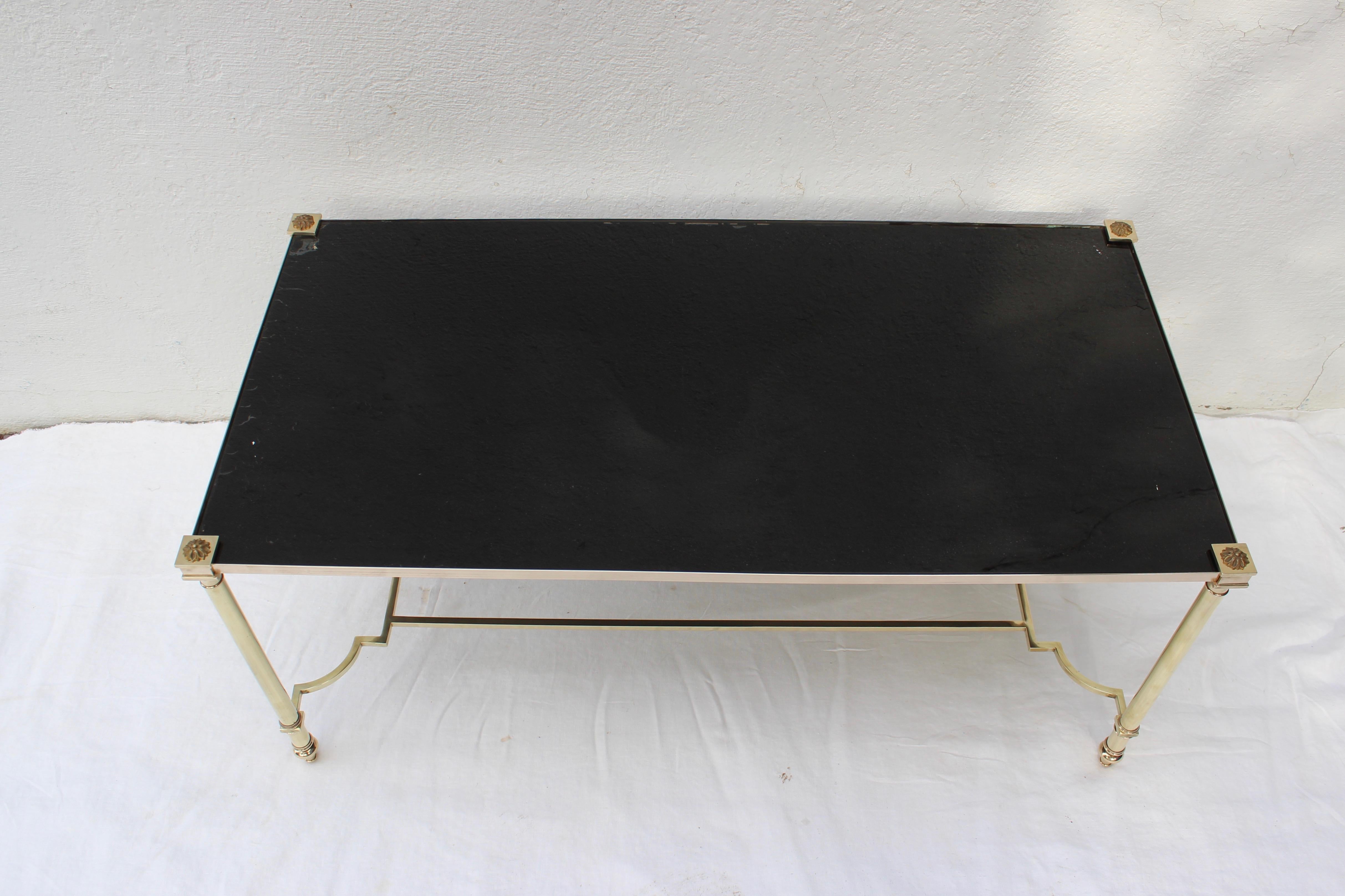 Bronze coffee table with painted black glass top by Maison Jansen.