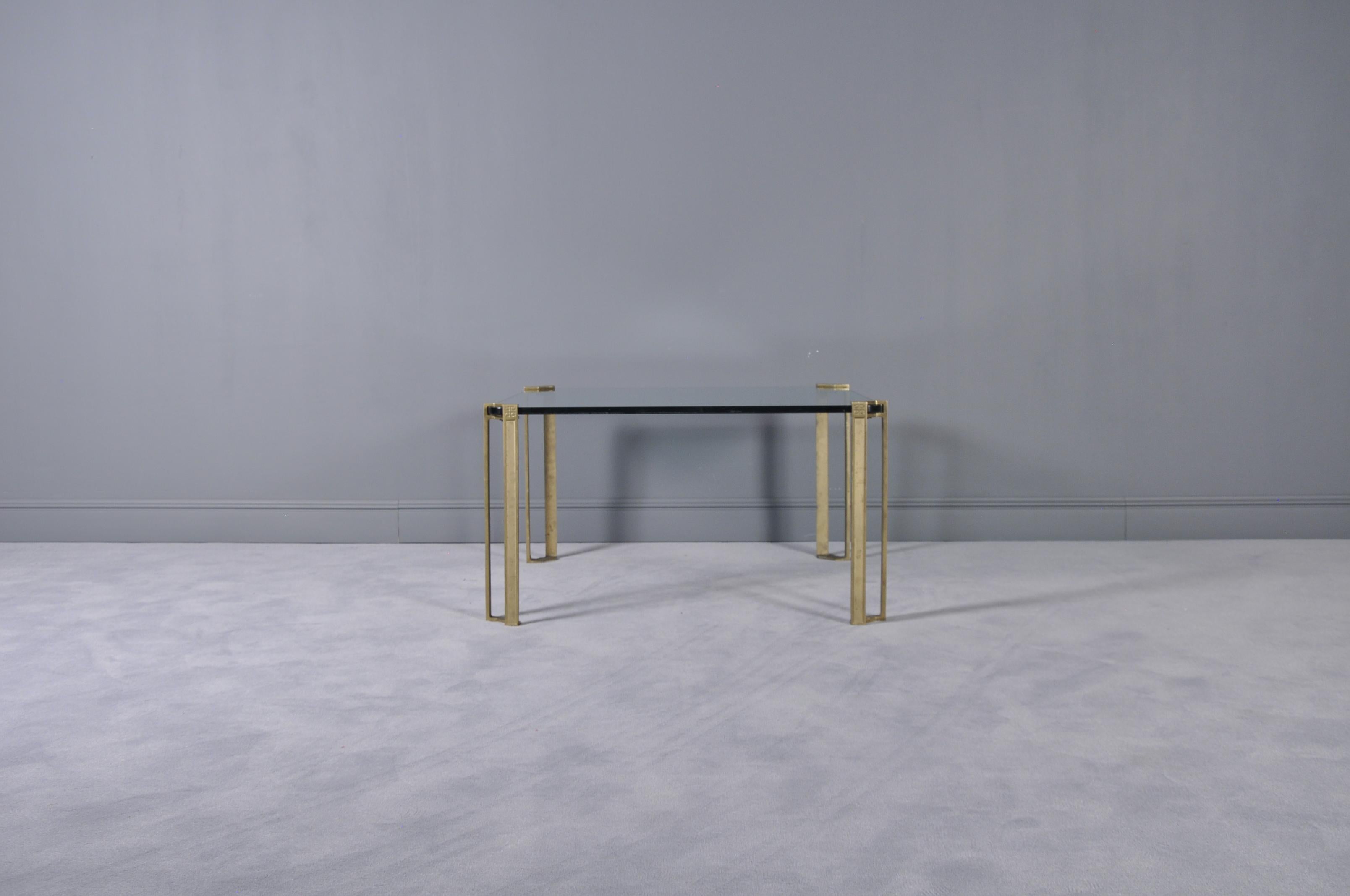 This side or cocktail table in solid bronze and glass with architectural detailing was designed by Peter Ghyczy and produced around the early 1970s.