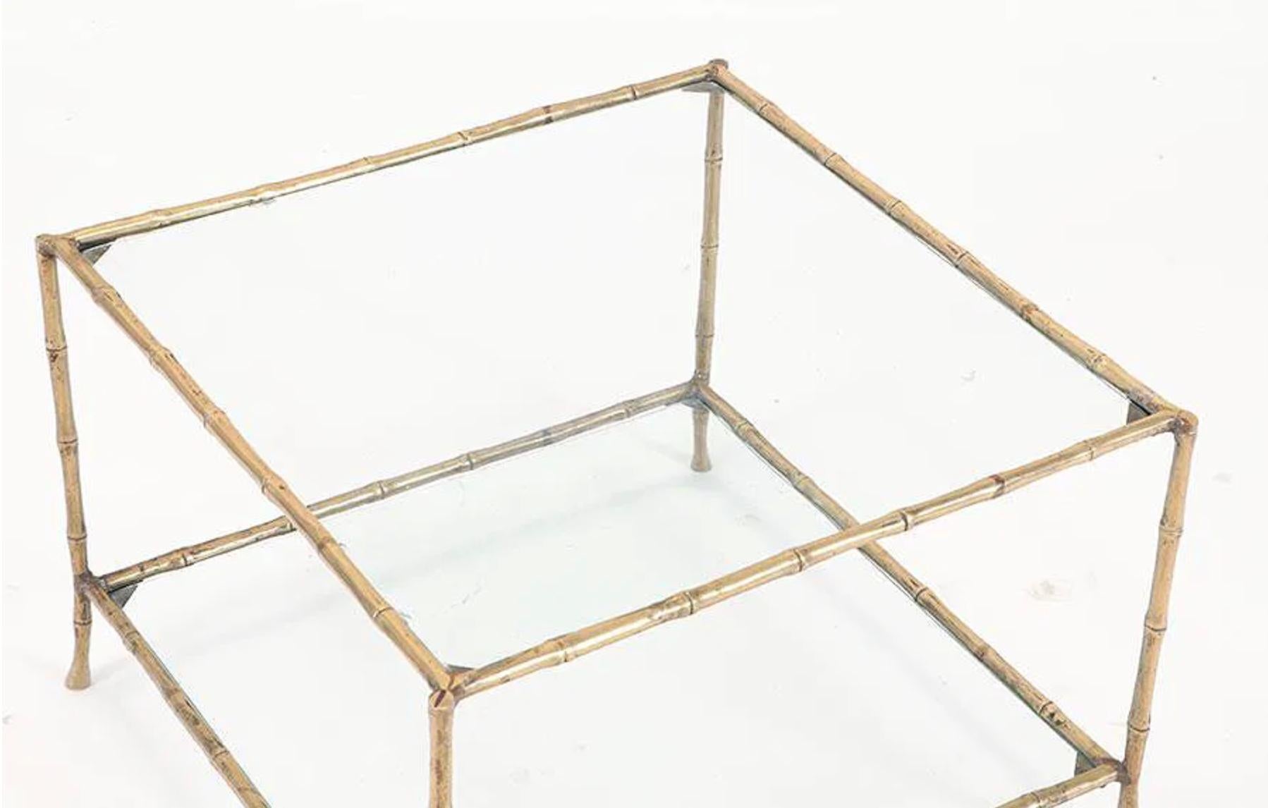 A chic and timeless bronze coffee table in the elegant faux bamboo style, crafted in the manner of the iconic French design house Maison Baguès. This piece captures the refined glamour of mid-20th century Parisian design with its finely cast bronze