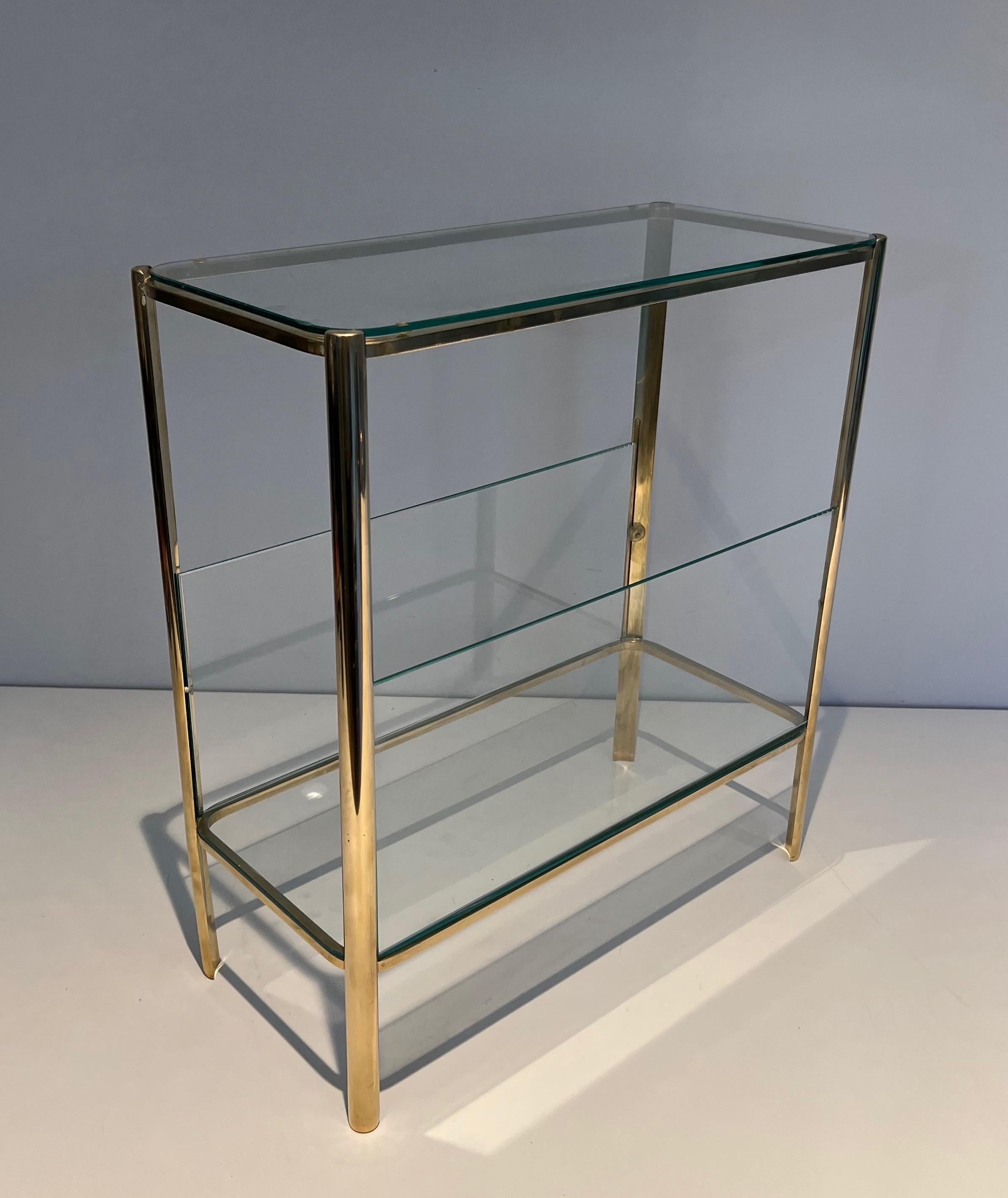 This magazine rack is made of bronze and glass. This is a very nice and rare model with glass panels on each side. This is a French work signed Jacques Théophile Lepelletier and stamped by Broncz. Circa 1970