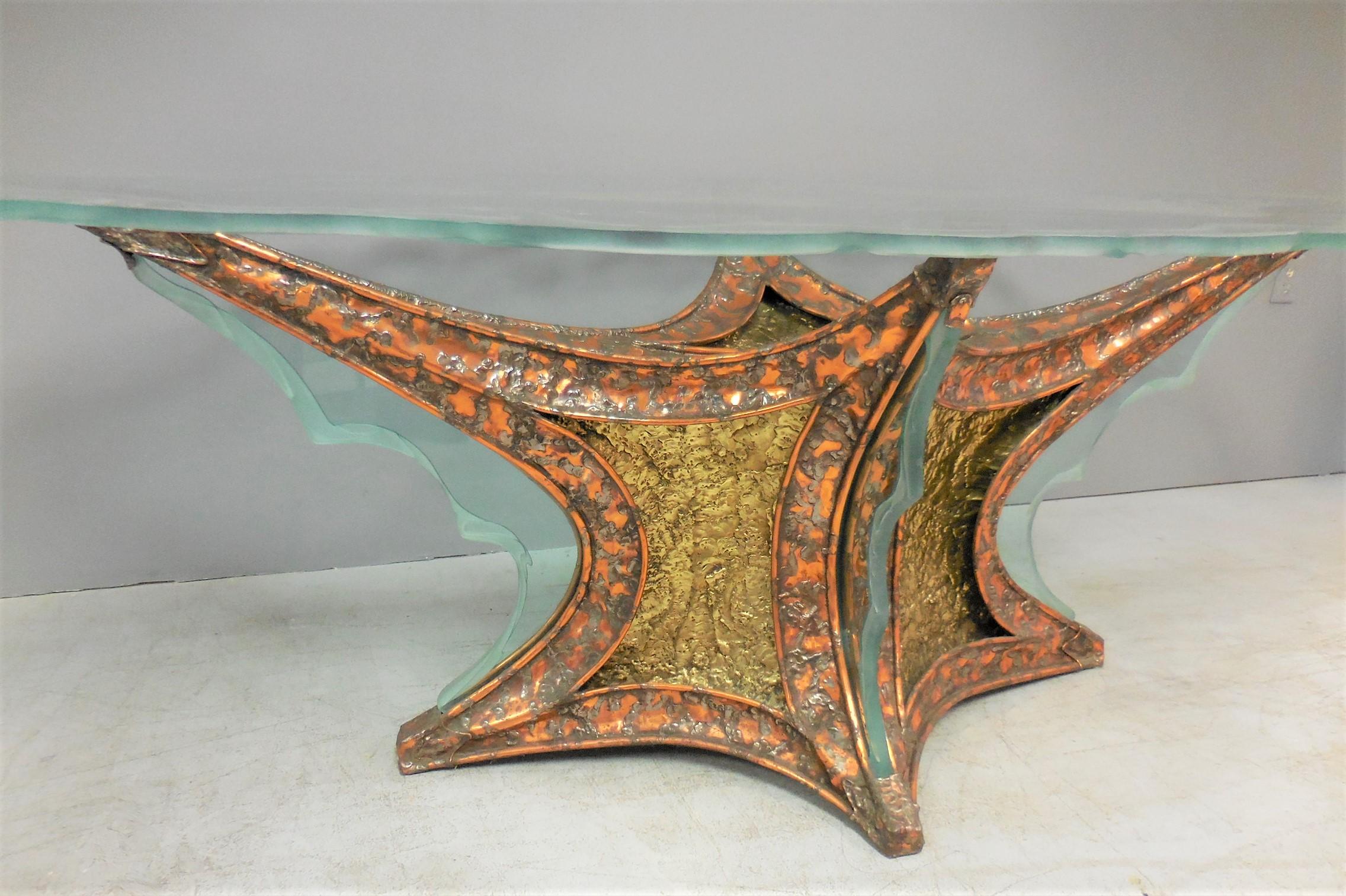 A large bronze base with etched glass insets, the custom glass top is also etched. A very unique table to say the least.