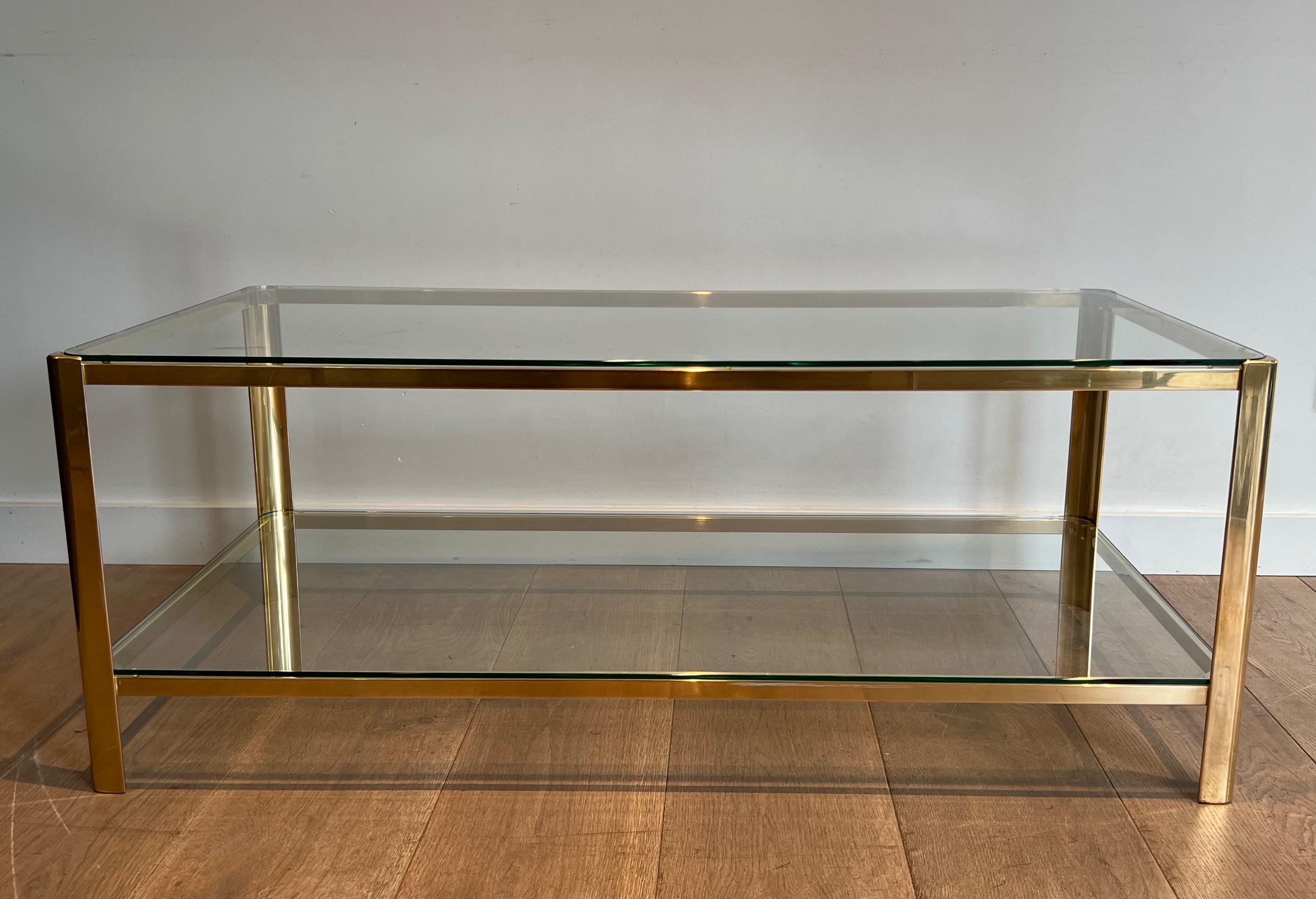 This beautiful two tiers coffee table is made of bronze with glass shelves rounded on corners. This is a very fine work signed Jacques Théophile Lepelletier and stamped by Broncz. Circa 1970.
