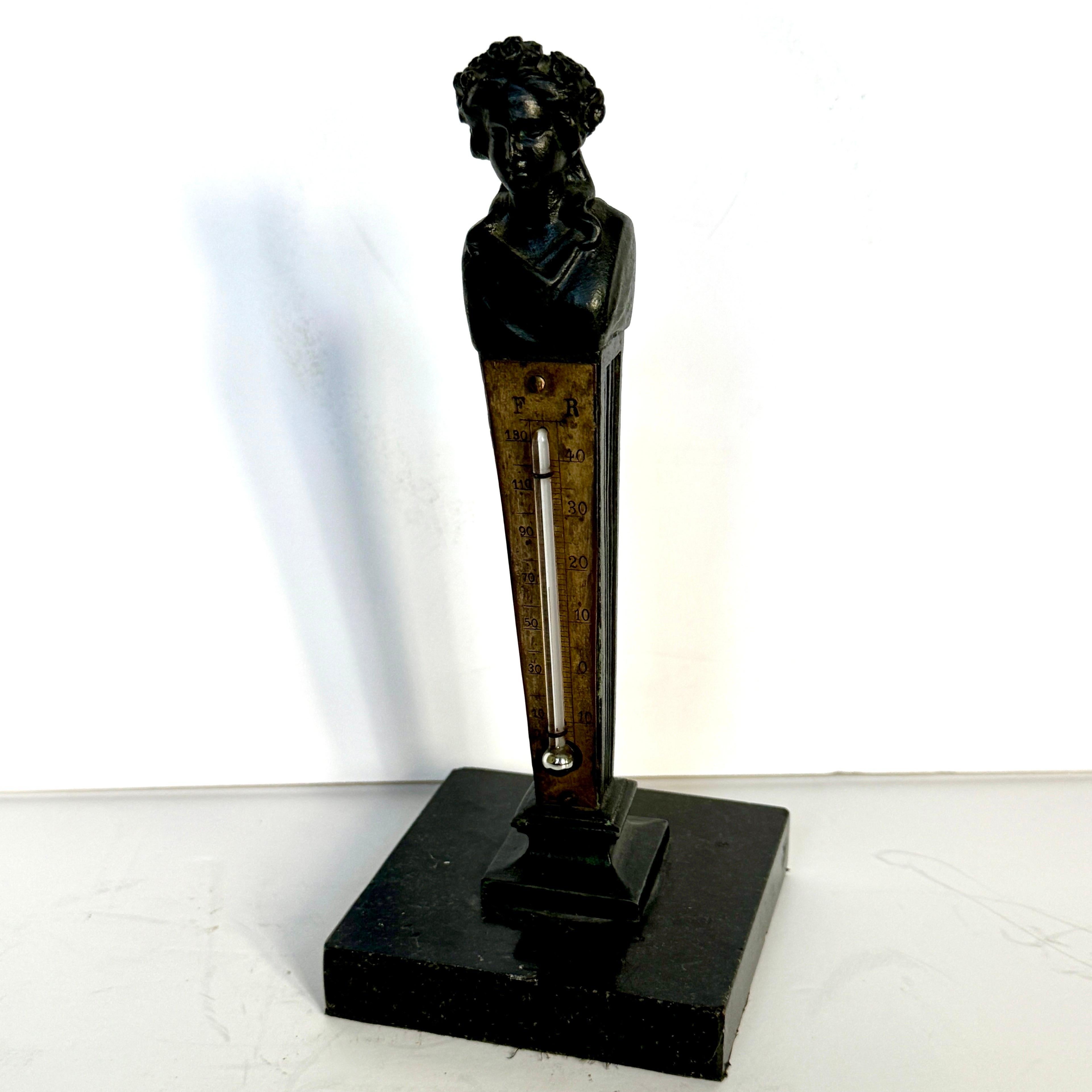 Charming Art Nouveau bronzed bust of a woman sitting atop a black marble base. This desk sculpture also functions as a thermometer. 