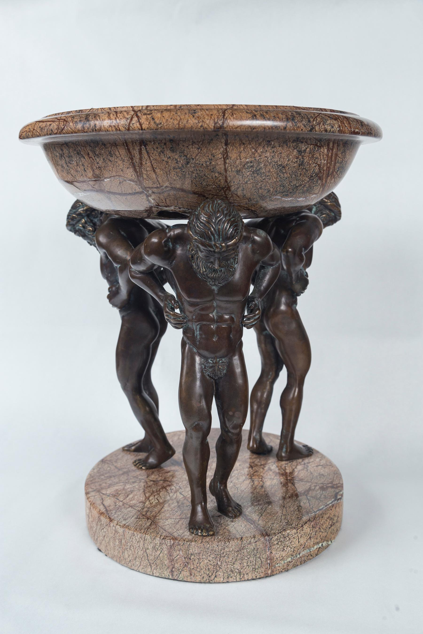 The separate bowl of light and darker brown  synthetic marble sits atop the hunched figures of Herculean men of bronze.  The bronze  figures  predate  the  synthetic faux  marble.  They are  19th century
The base is 10 inches in diameter, while the