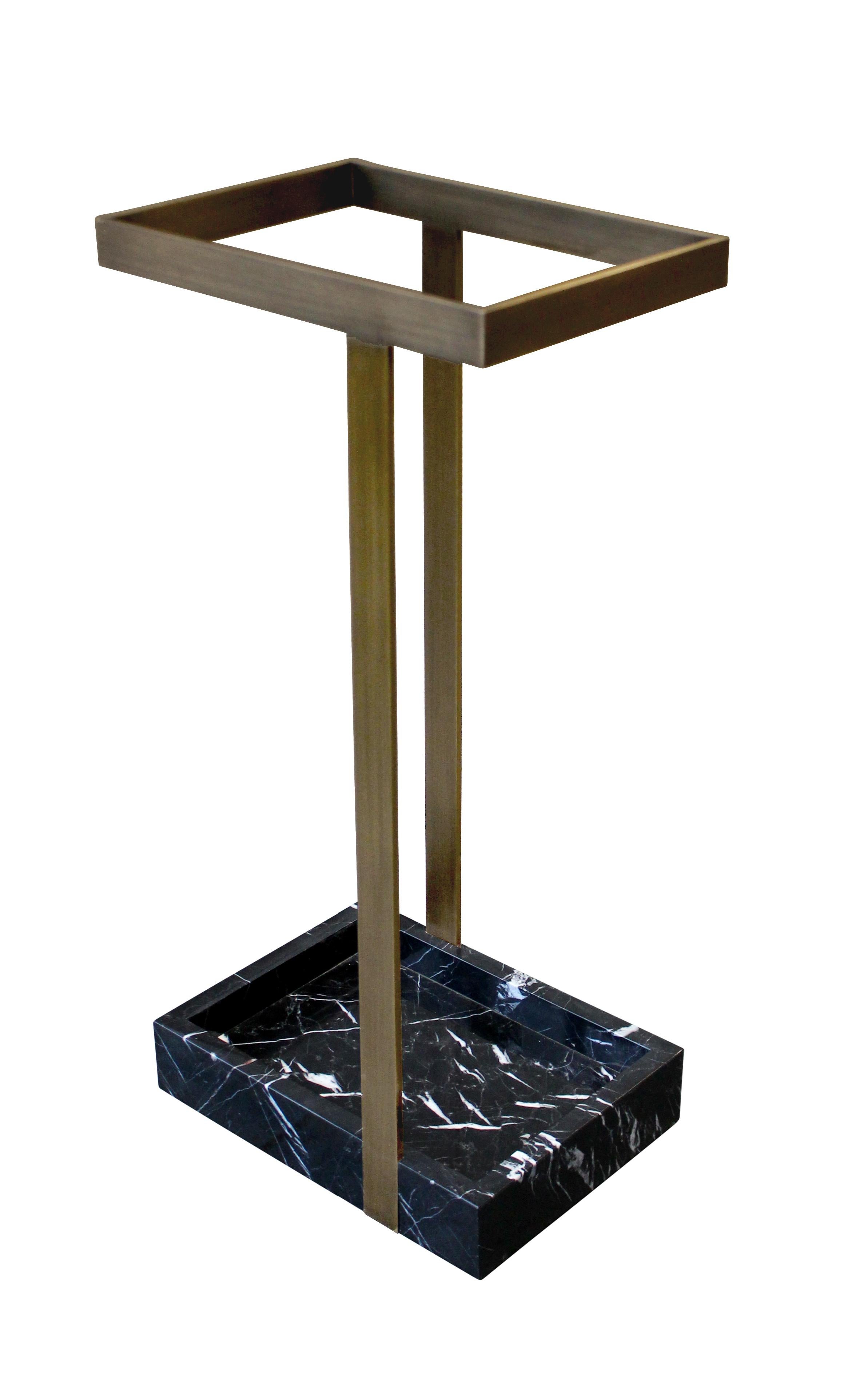 This subtle yet striking umbrella stand creates an arresting focal point in a foyer or vestibule. Shown here in patinated bronze with nero marquina marble, the piece is handmade to order in New York City and can be specified in any number of custom