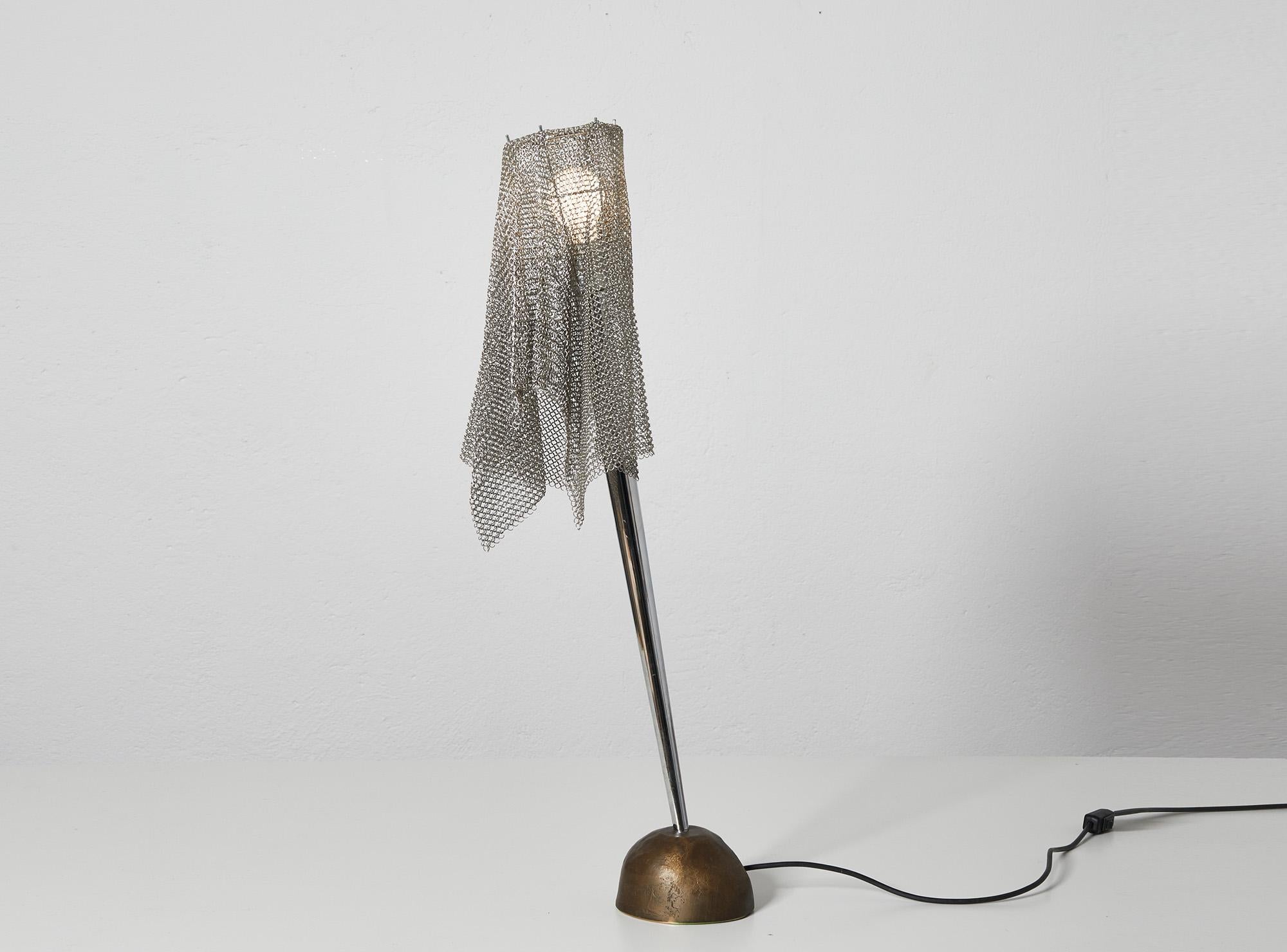 Ecate table lamp or light sculpture from the Milano-Torino series by Toni Cordero for Artemide, Italy.

The Ecate is the most sought after model from this series with its bronze fusion base inspired by a natural rock. 

The conical metal slanted